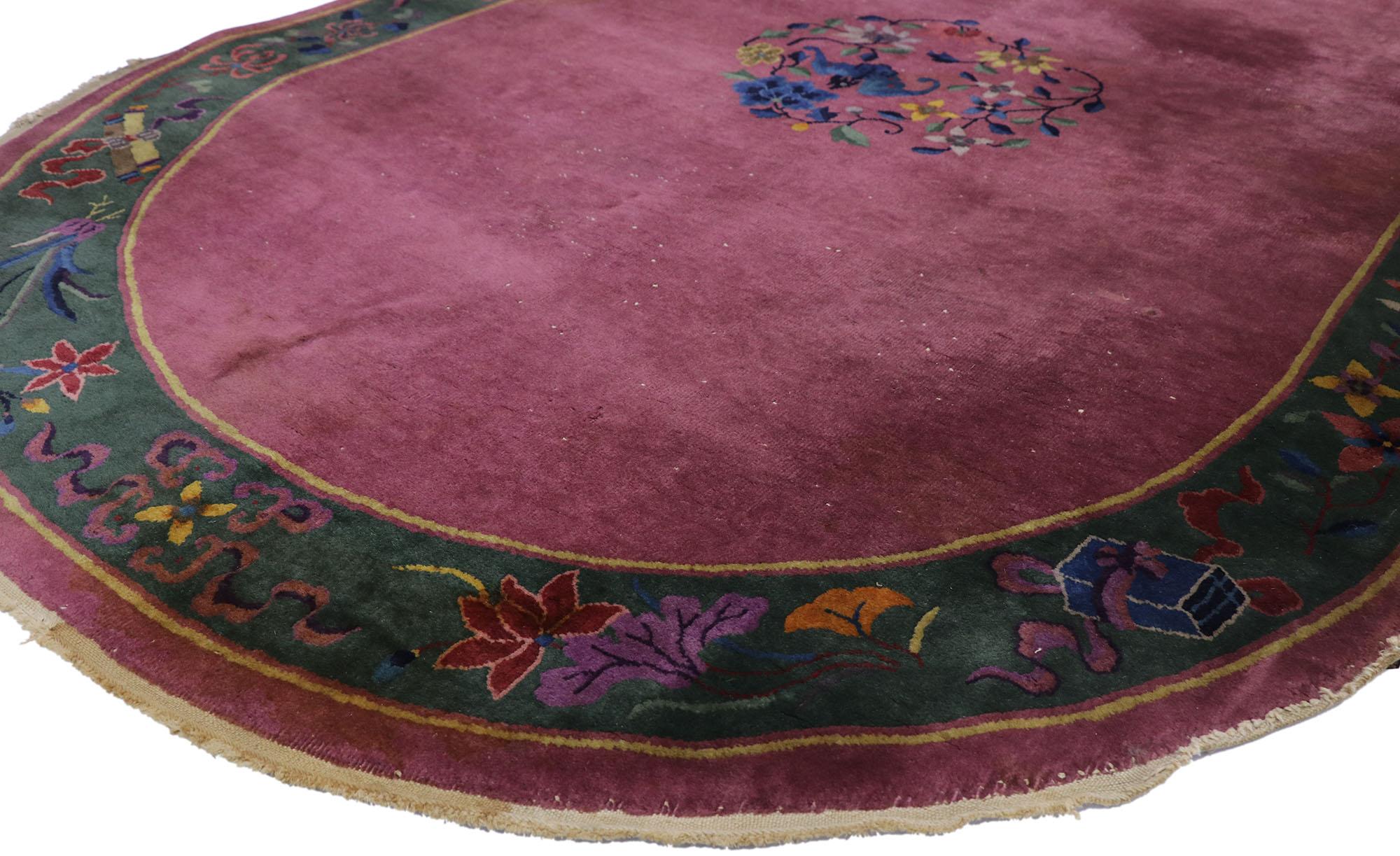 77618, antique Chinese Art Deco oval rug inspired by Walter Nichols. Channeling the famed Walter Nichols style of the 1920s and 1930s, this hand knotted wool antique Chinese Art Deco rug features a burgundy wine field with an open floral medallion