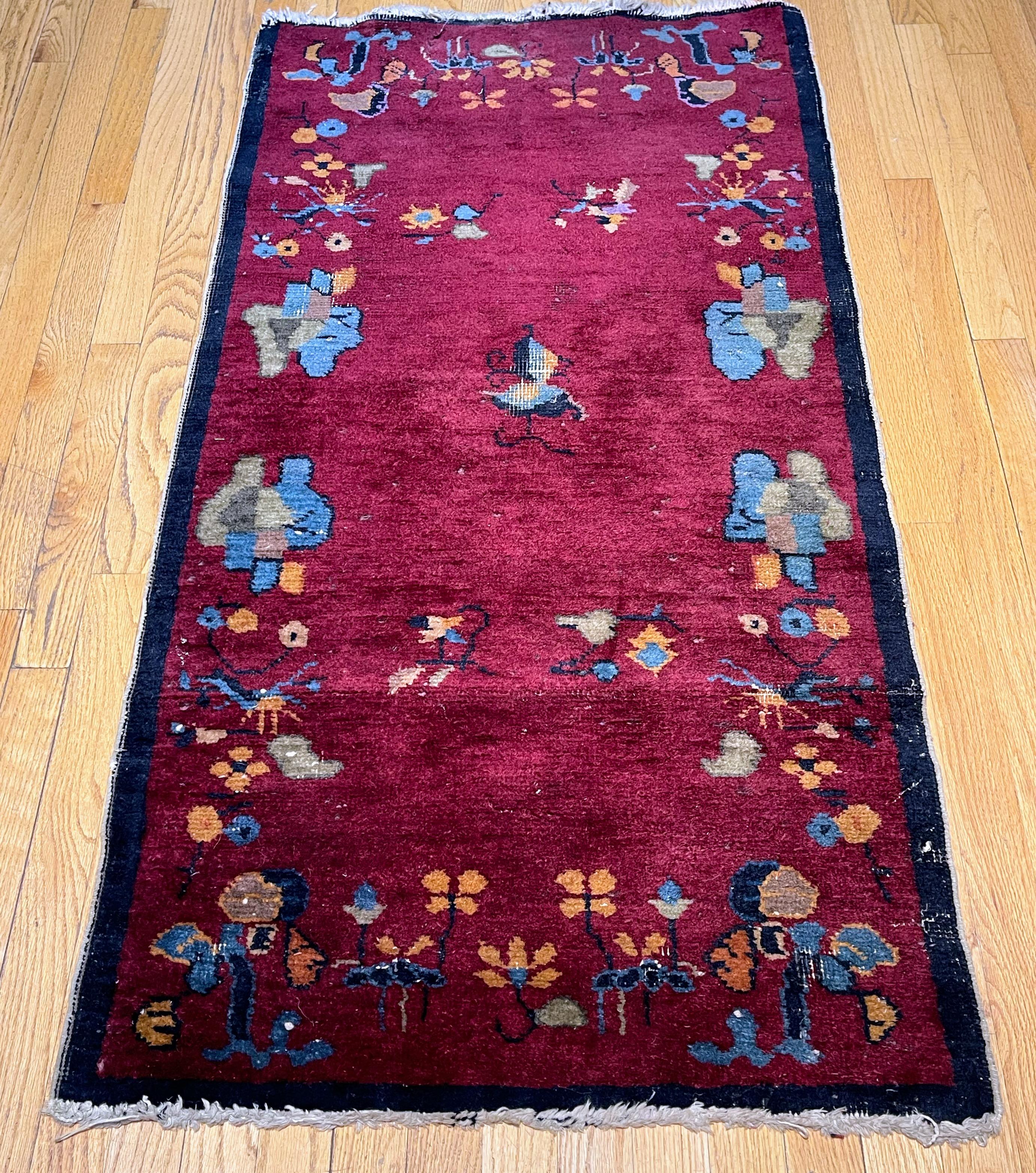 This rug was hand woven in China. With a maroon field and small border in indigo blue it is decorated with green, yellow and blue carnations. There are human figures, birds and animals in this very cute art deco rug. Wears in this rug are consistent