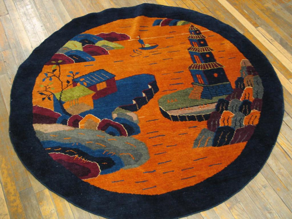 This rather rare round rug features a landscape design with layered parti-colored rocks, a four story pagoda and simple Dwellings separated by an orange-rust inlet with a small sailing vessel. Looks like a round fan painting, but larger and with