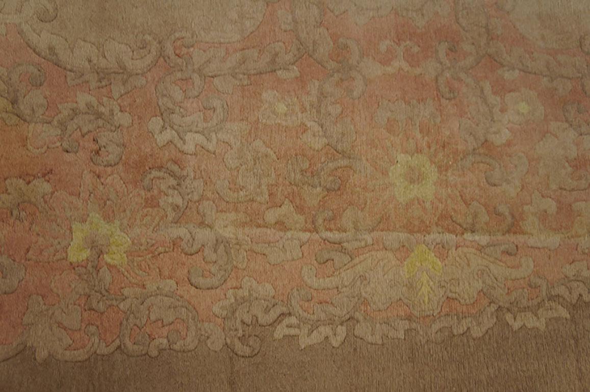 Definitely a soft pink tone-on-tone carpet with a complex and dense border of leaves and flowers. Very much a boudoir carpet. Elaborate contour carving intact. Good condition. From Peking (Beijing) rather than Tientsin (Tianjin).