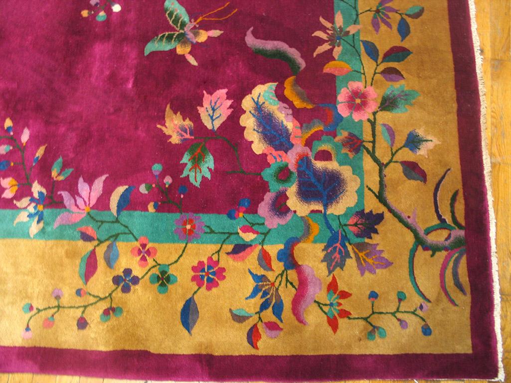 Antique Chinese Art Deco Rug with a fuchsia background, golden edge,floral design and size 9'0