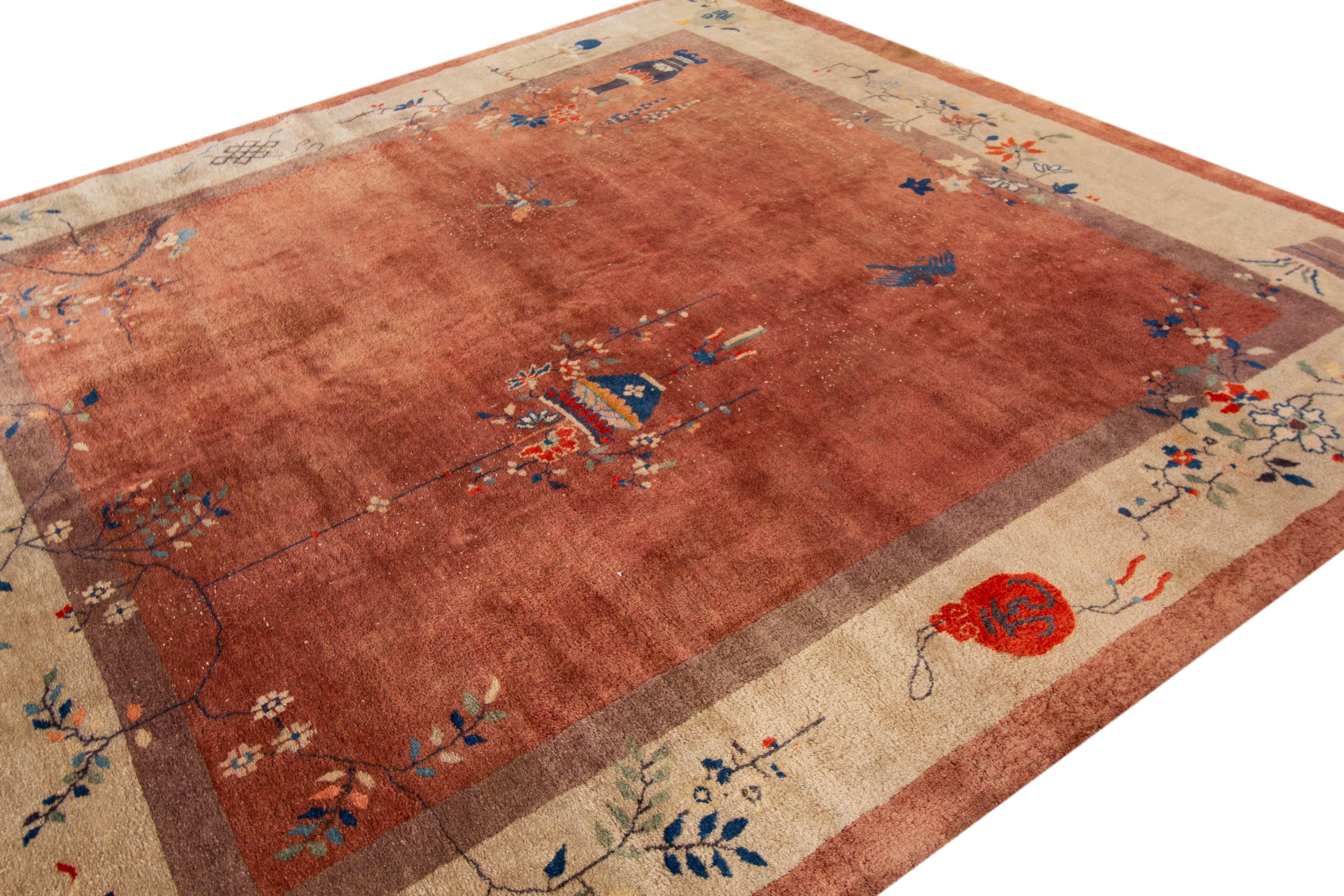 A hand-knotted antique Chinese rug with a floral Art Deco design. This rug measures 9'10
