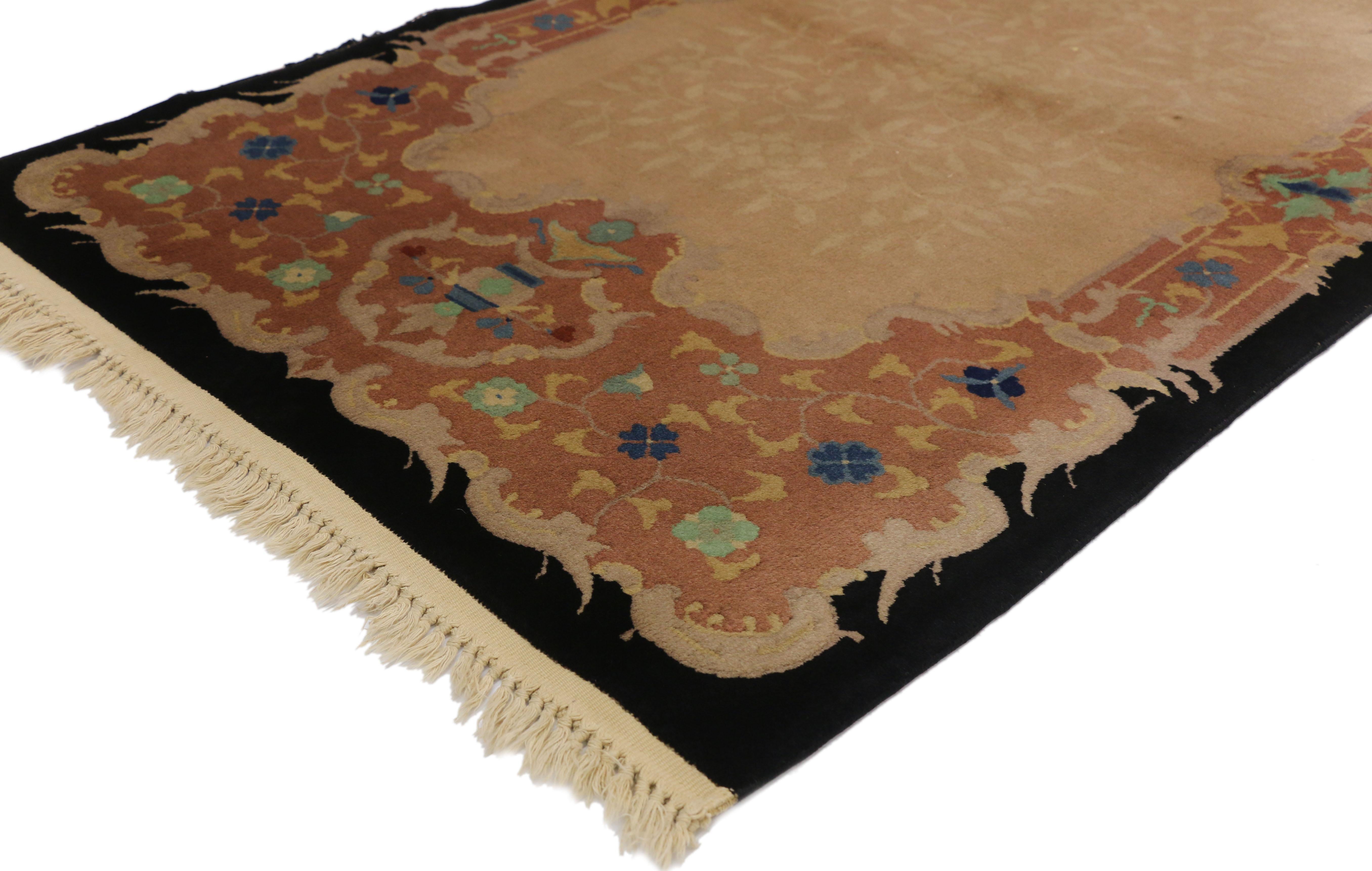 70718 antique Chinese Art Deco rug with European Influenced Chinoiserie style. This hand knotted wool antique Chinese Art Deco rug features a subtle all-over arabesque pattern spread across a champagne field enclosed by an ornate floral border. The