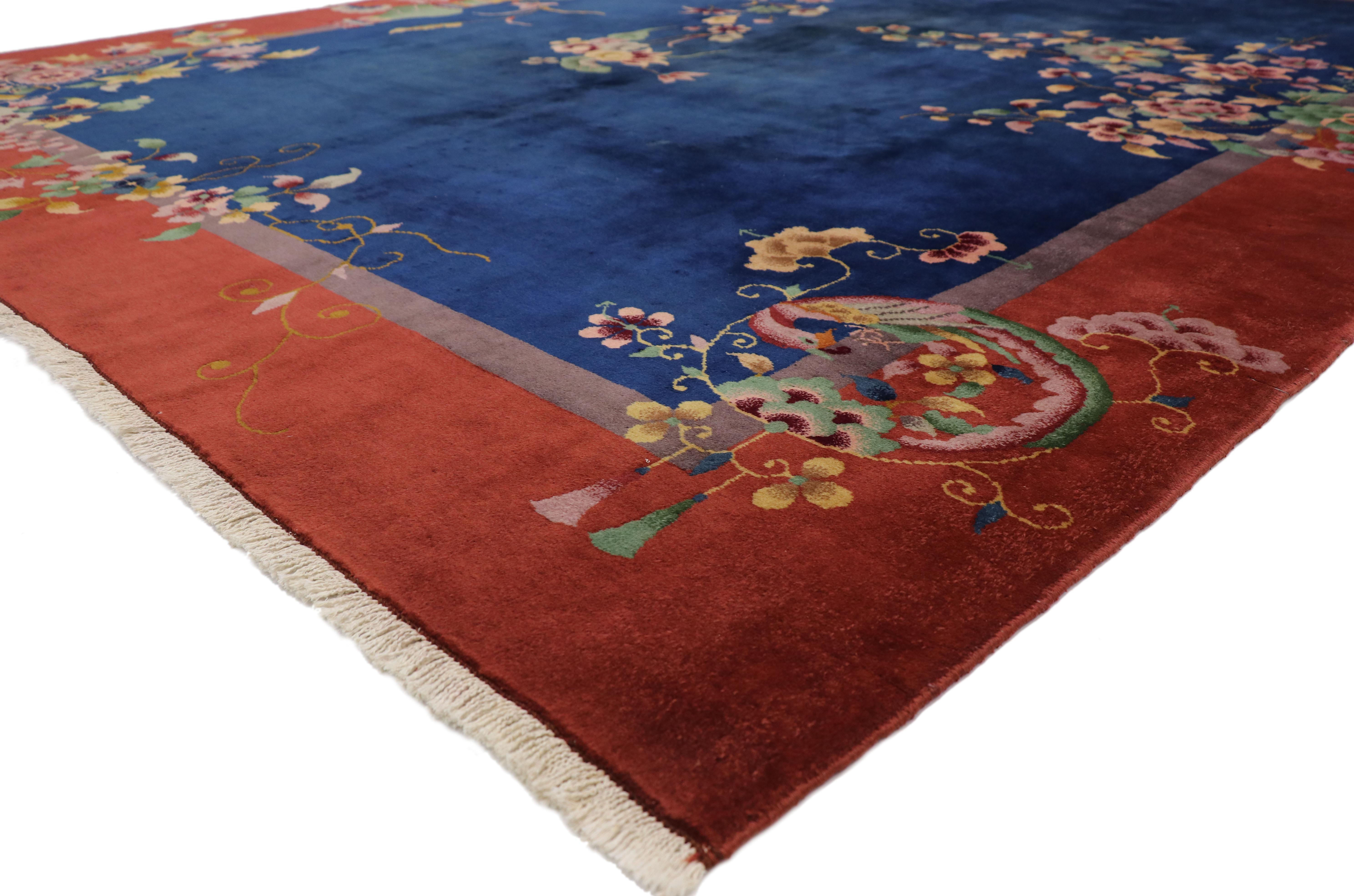 77354 Antique Chinese Art Deco Rug with Jazz Age Chinoiserie Style. This hand-knotted wool antique Chinese Art Deco rug features elegant sprays of flowers interlaced with a variety of auspicious symbols overlaid upon an abrashed navy blue field and