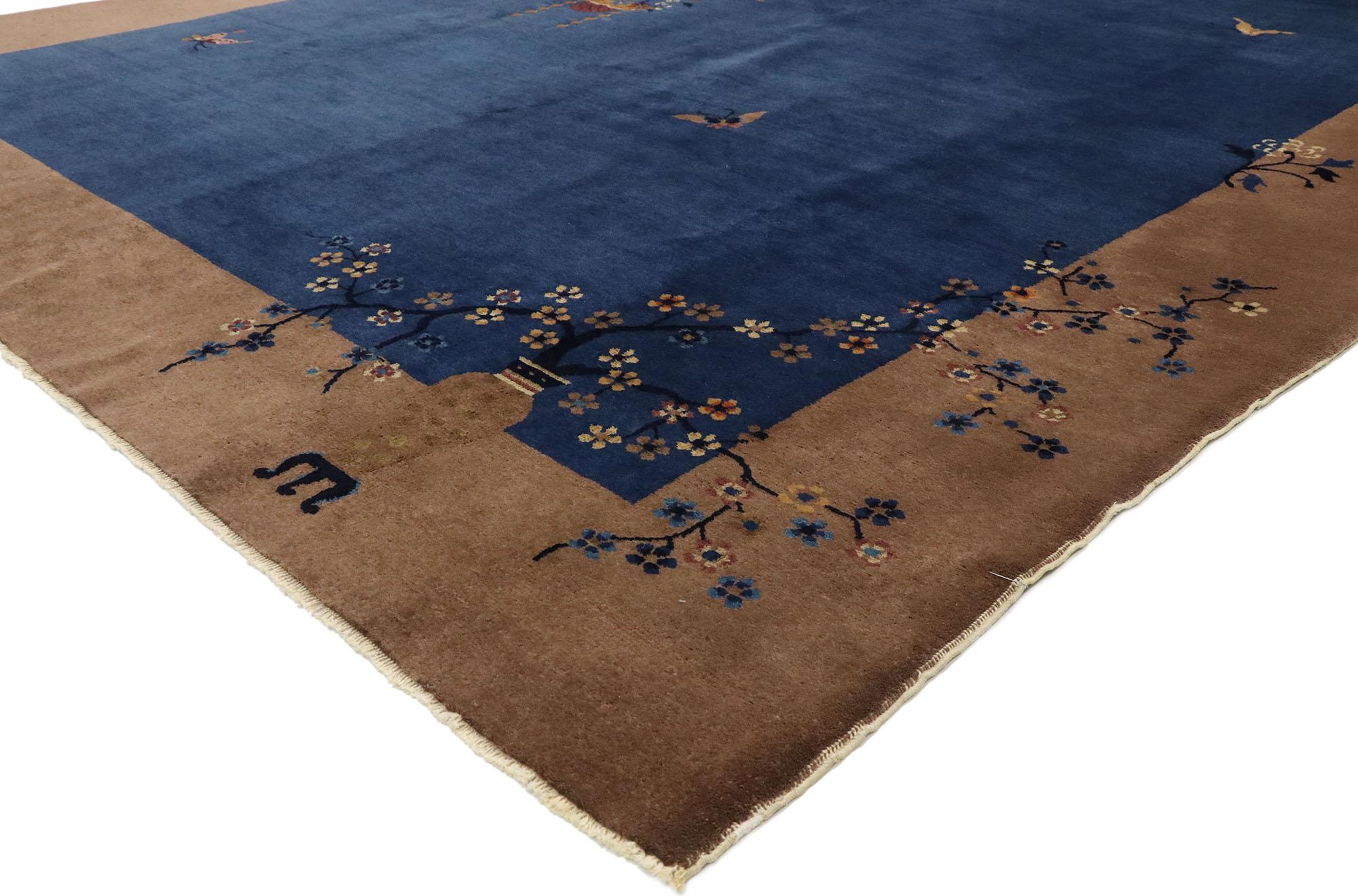 77449, antique Chinese Art Deco rug with Ming Dynasty style. This hand knotted wool antique Chinese Art Deco rug features a color-blocked field and border scheme festooned with asymmetrical florals in opposite corners across the composition,