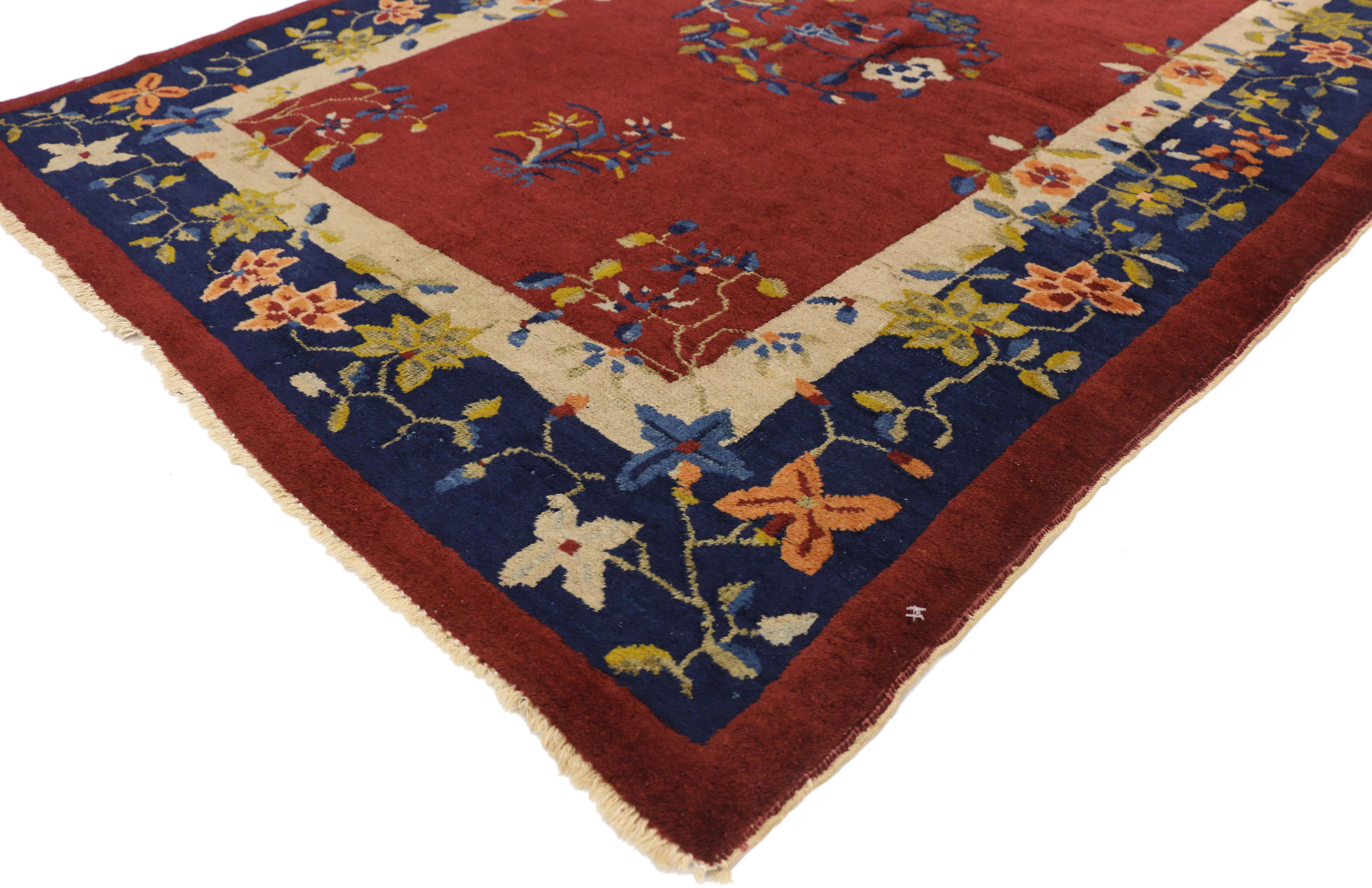 72233 antique Chinese Art Deco Style Accent rug. This hand knotted wool antique Chinese Peking rug features a rounded open center medallion comprised of a swirl of lotus flowers floating on an abrashed brick red field. Glorious sprays of intertwined