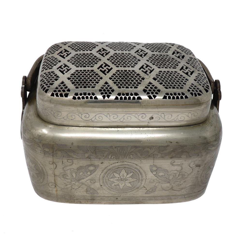 Antique Chinese Bai-tong Hand Warmer. The  large rectangular bun form has a hinged overhead handle and filigree pierced lid in a hexagonal pattern. The solid sides has engraved decoration of  flower medallions alternating with butterflies between