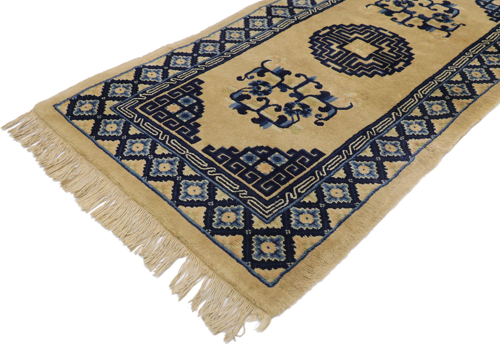 77588 antique Chinese Baotou rug with Art Deco style. This hand-knotted wool antique Chinese Baotou rug features a rounded fretwork medallion enclosing a center rosette floating in the center of an abrashed taupe field. Corresponding fretwork