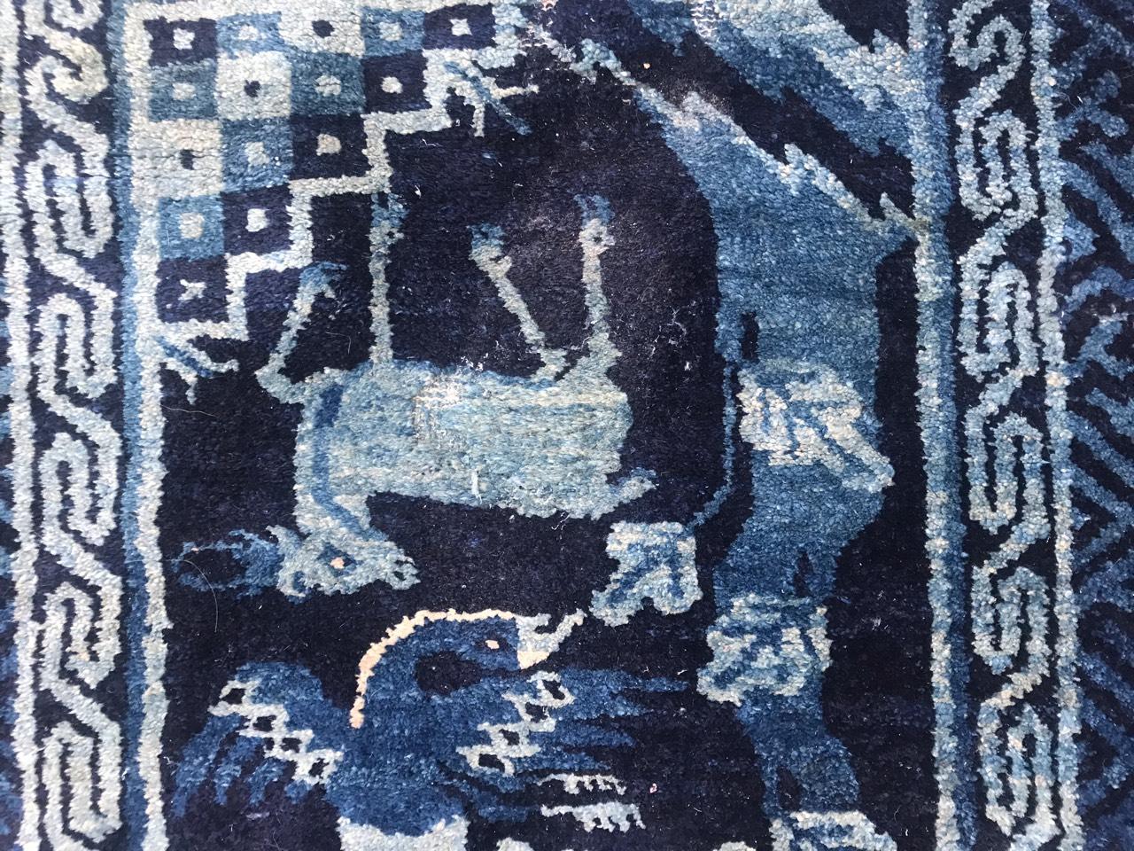Beautiful little late 19th century Chinese rug with a Chinese design with dogs, and beautiful colors with blue, entirely hand knotted with wool velvet on cotton foundation.