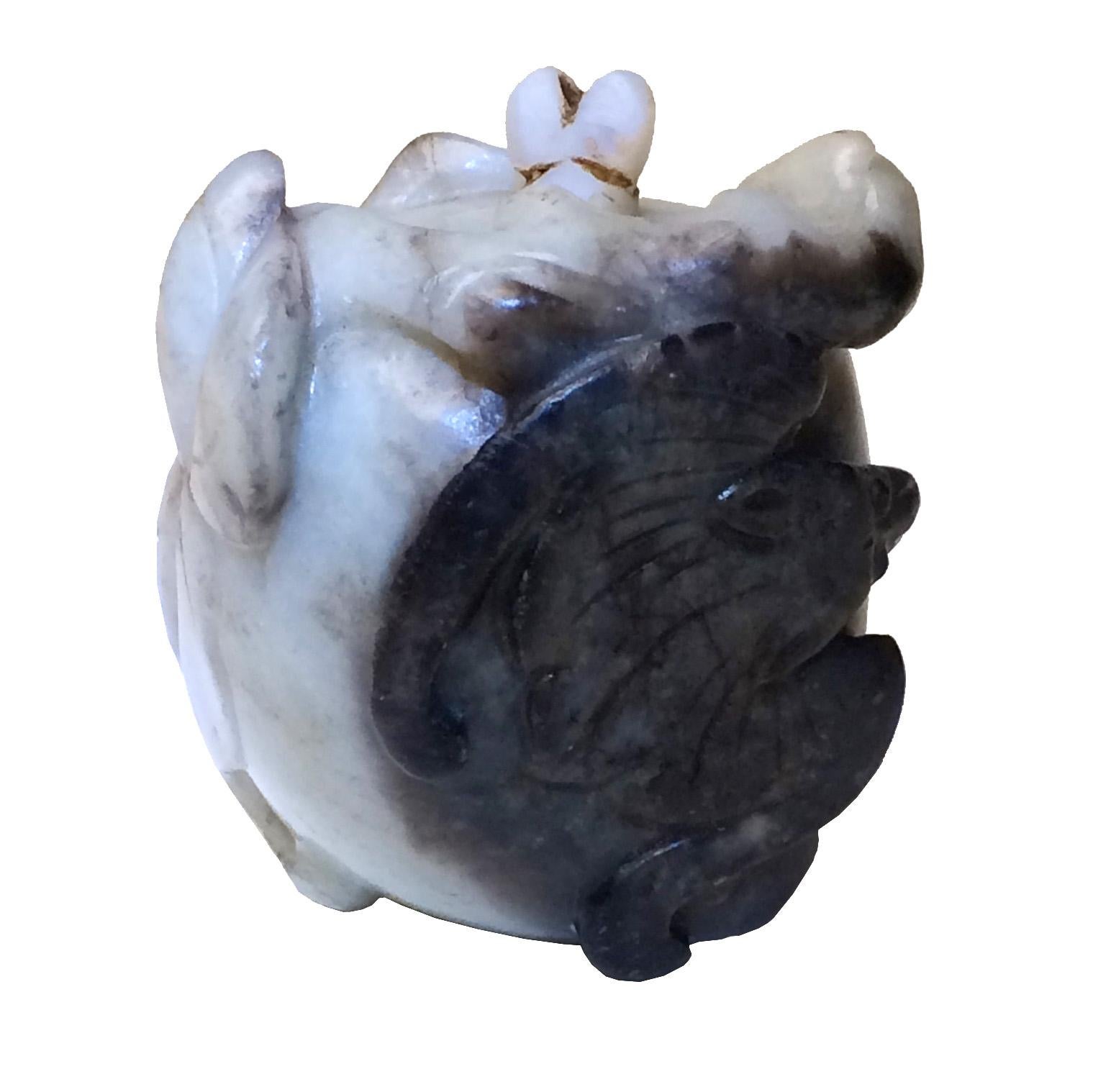 Chinese Black-and-White Jade Pebble Snuff Bottle, nephrite carved in the overall shape of a white peach of longevity with a black bat of happiness resting with wings partially open in relief on the side of the  peach, carved in the entirety in a