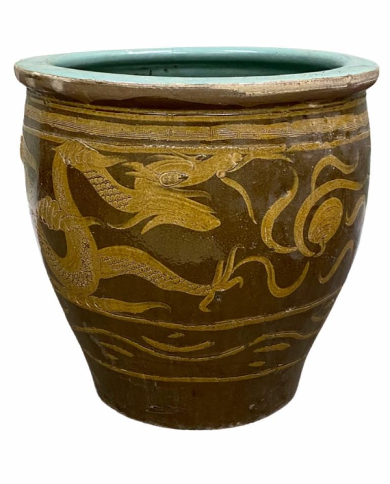 Late 19th century black egg Chinese art pottery pot featuring a Asian dragon along the front. These Pots over a 120 years were used for the storage of black 