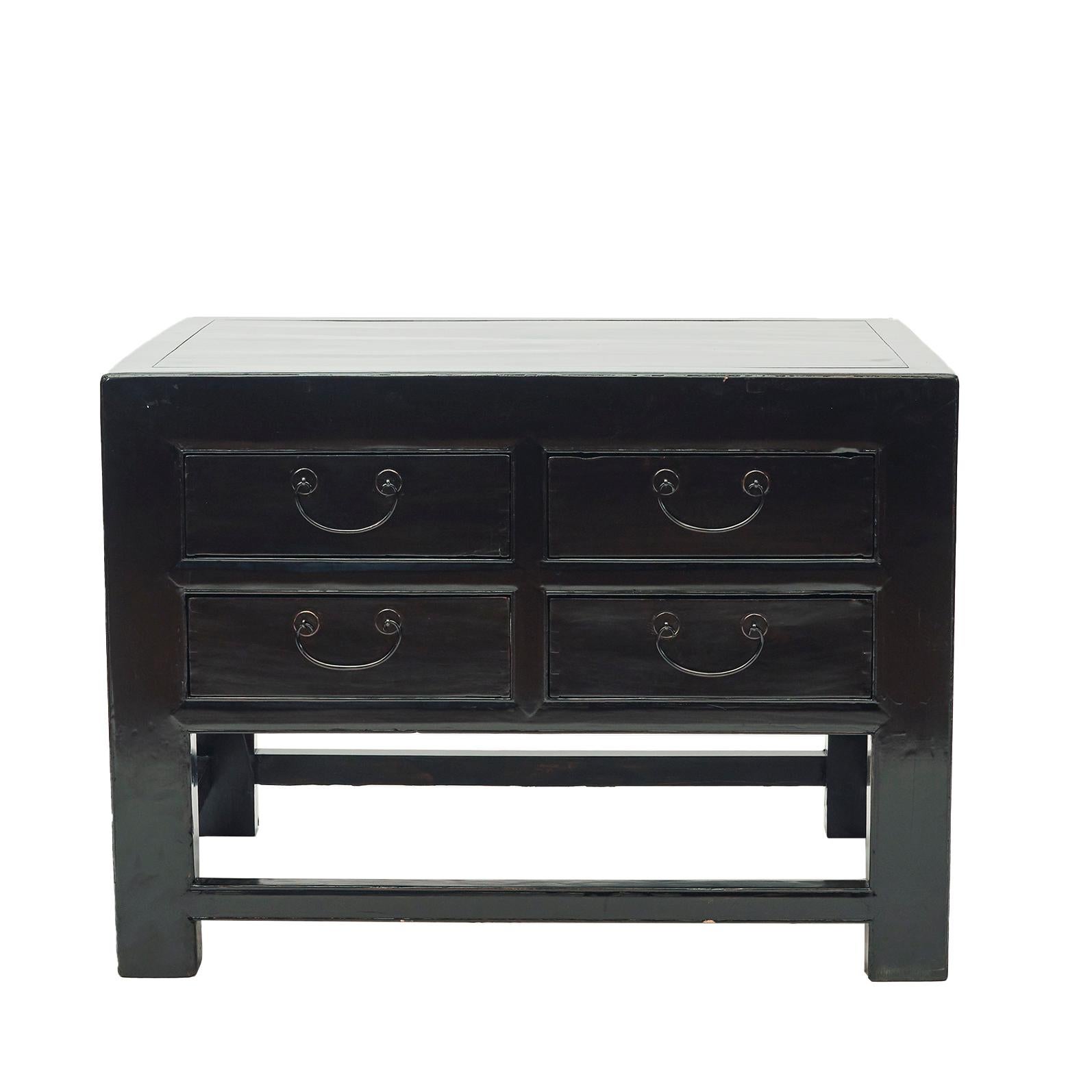 Freestanding black lacquered center console table.

Features a front with four drawers with pulls and profiled fillings on the three other sides.
Refined and elegant art deco table with its clean lines and minimal ornamentation.

The table top panel