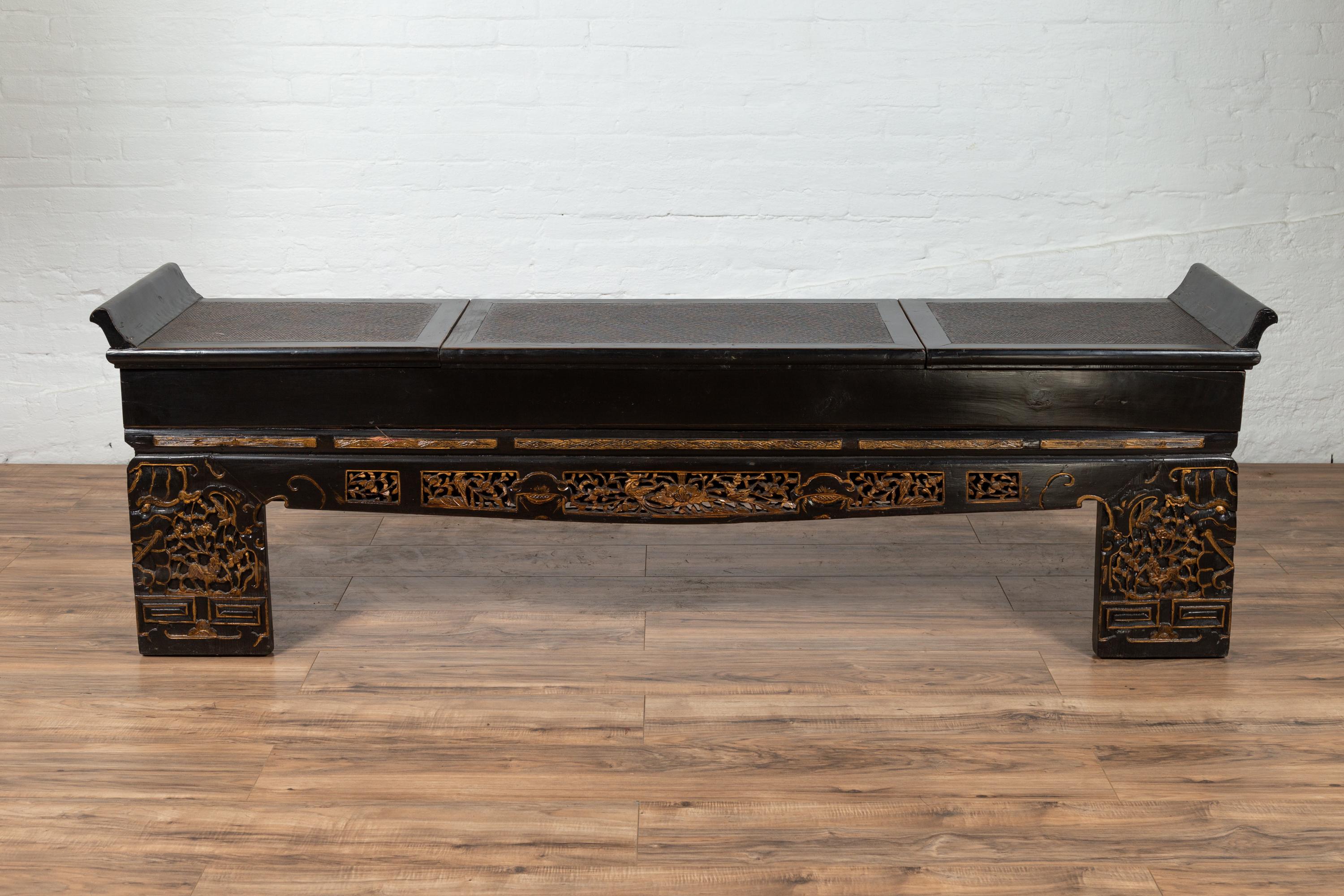 An antique Chinese Ming Dynasty style black lacquered low console table with hidden storage and rattan inset from the 20th century with everted flanges, perfect to be used as a bench. We currently have two pieces available, priced and sold