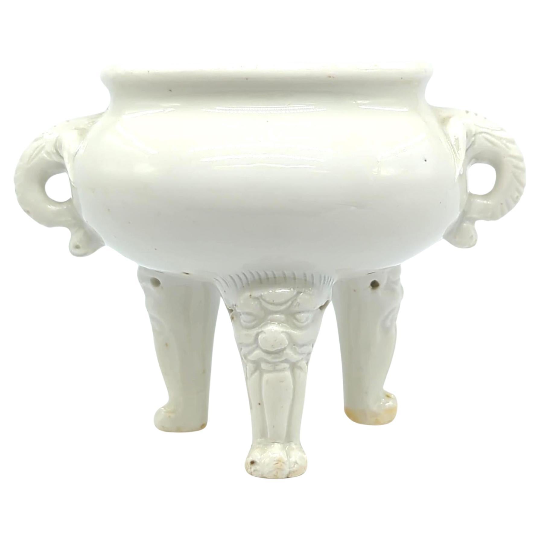 This 18th-century Kangxi period blanc de chine Chinese porcelain tripod censer is an exemplar of refined craftsmanship and intricate detailing, hallmarks of the Kangxi era. The censer is crafted in the blanc de chine technique, known for its milky