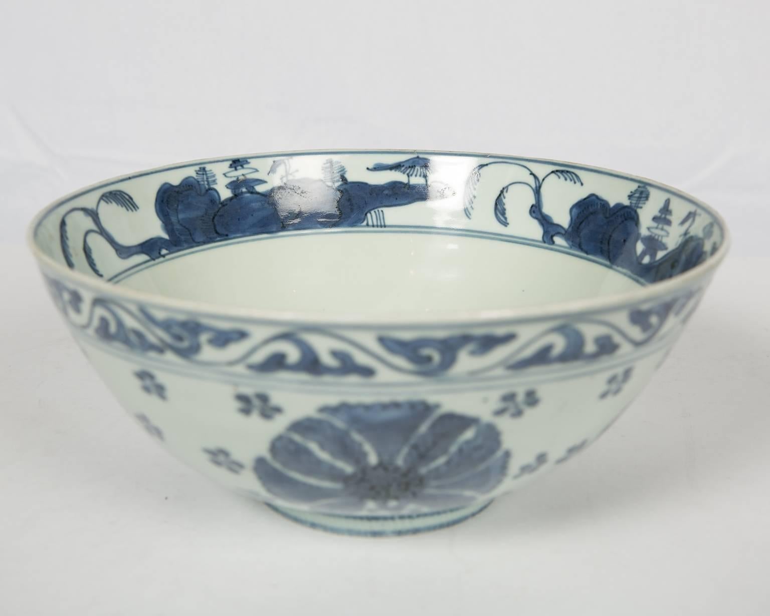 We are pleased to offer this delicate Chinese blue and white porcelain bowl, made during the Daoguong reign, between 1820-1850. The bowl is hand-painted in the traditional, elegant Ming style. The outside of the bowl is decorated with large flower