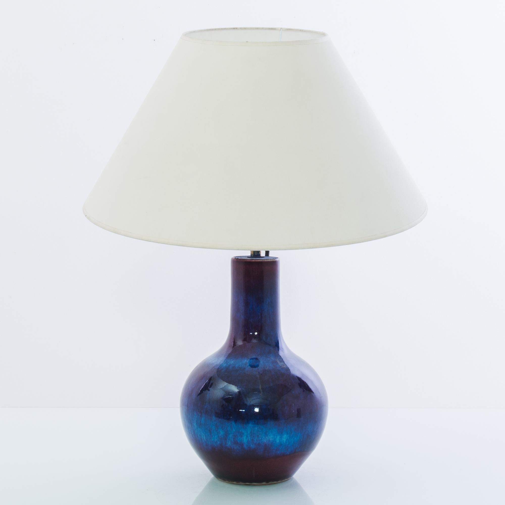 A vintage Chinese vase, fitted with an adjustable brass fixture and E26 lighting socket. The widely striped dark blue glaze creates a vivid visual impact. Textured glazes, attractive colors and organic shape grants a sensuous tactility to the form.