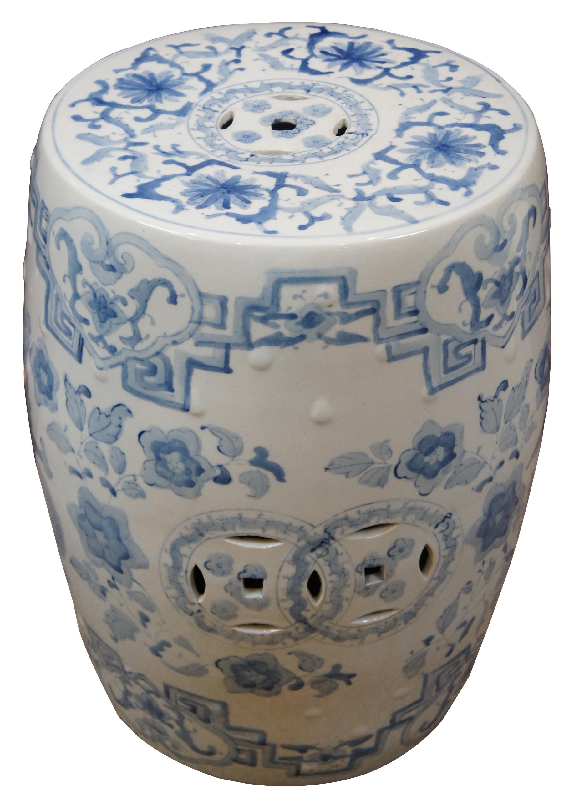 Antique blue and white reticulated floral Chinese porcelain / ceramic garden stool, plant stand or side table featuring a Phoenix / rooster and serpent / dragon surrounded by flowers.
  