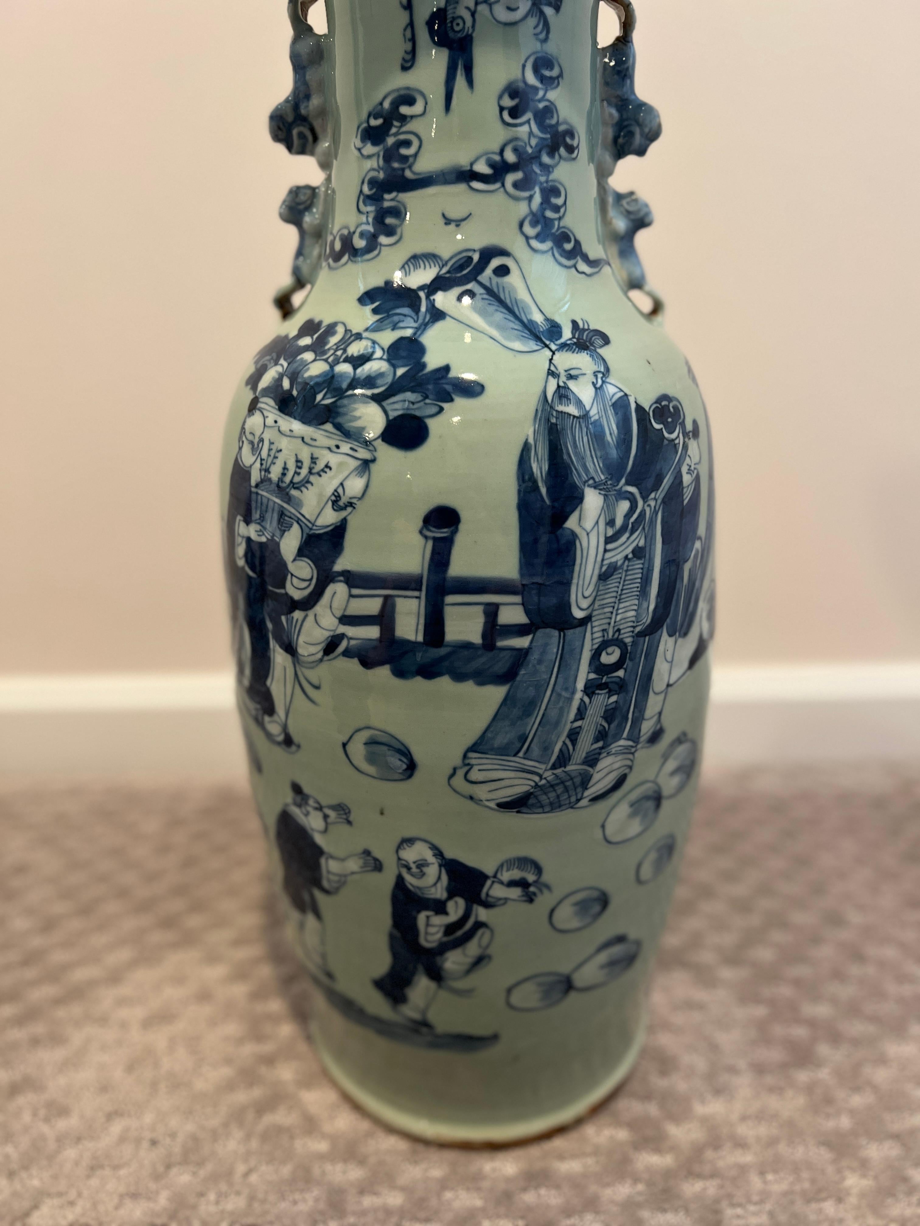 Chinese, 19th century.

A large Chinese floor vase having a celadon ground and blue and white underglaze decoration to the body. The underglaze decoration depicts high ranking officers and officials in the garden playing with the young children