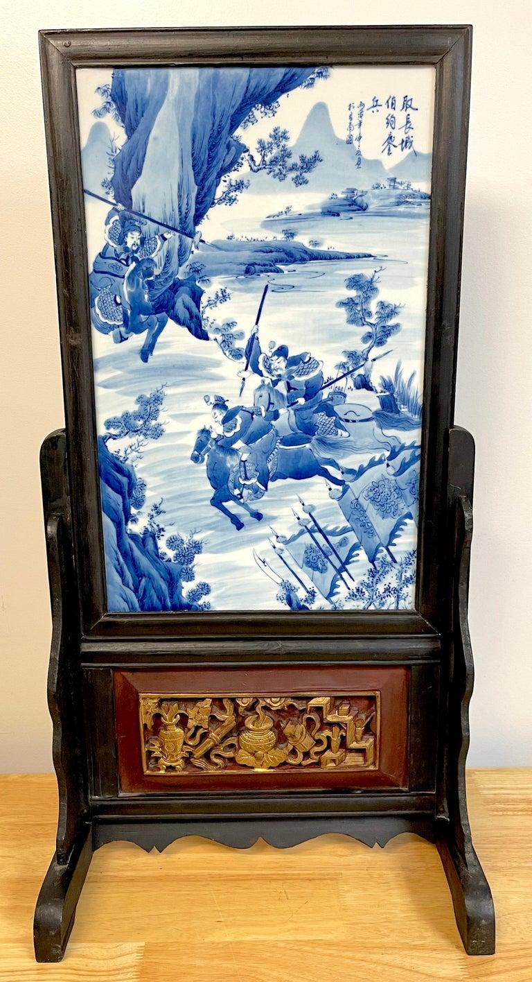 Antique Chinese Blue and White Warrior Scene Giltwood and Lacquer Table Screen
An exquisite antique Chinese blue and white warrior scene table screen, mounted on a giltwood and lacquer base, showcases exceptional craftsmanship and historical