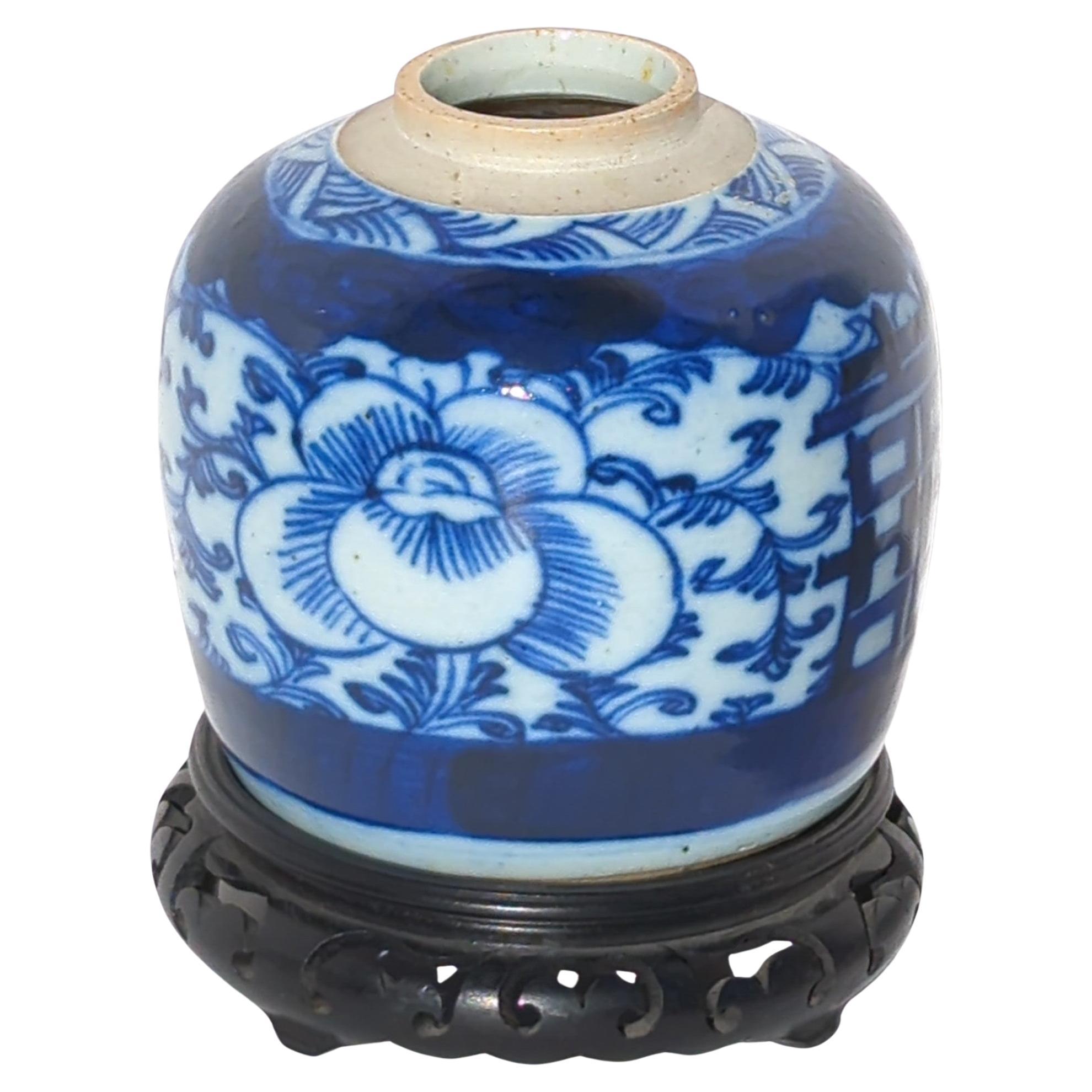 Antique Chinese Qing dynasty blue and white ginger jar, hand painted with two double happiness characters on scrolling foliage background with large peony blossoms in cobalt blue. 

Comes with hardwood stand.

Vase size: H: 5
