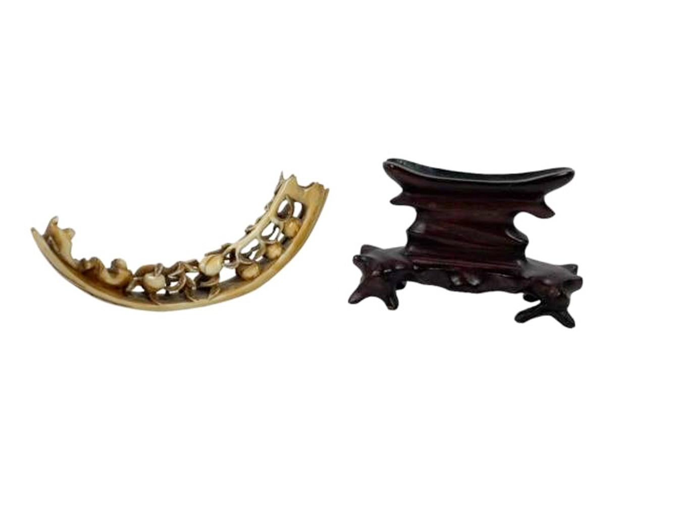 Chinese Export Antique Chinese Boar's Tusk with Carved Peaches on a Carved Hardwood Stand For Sale