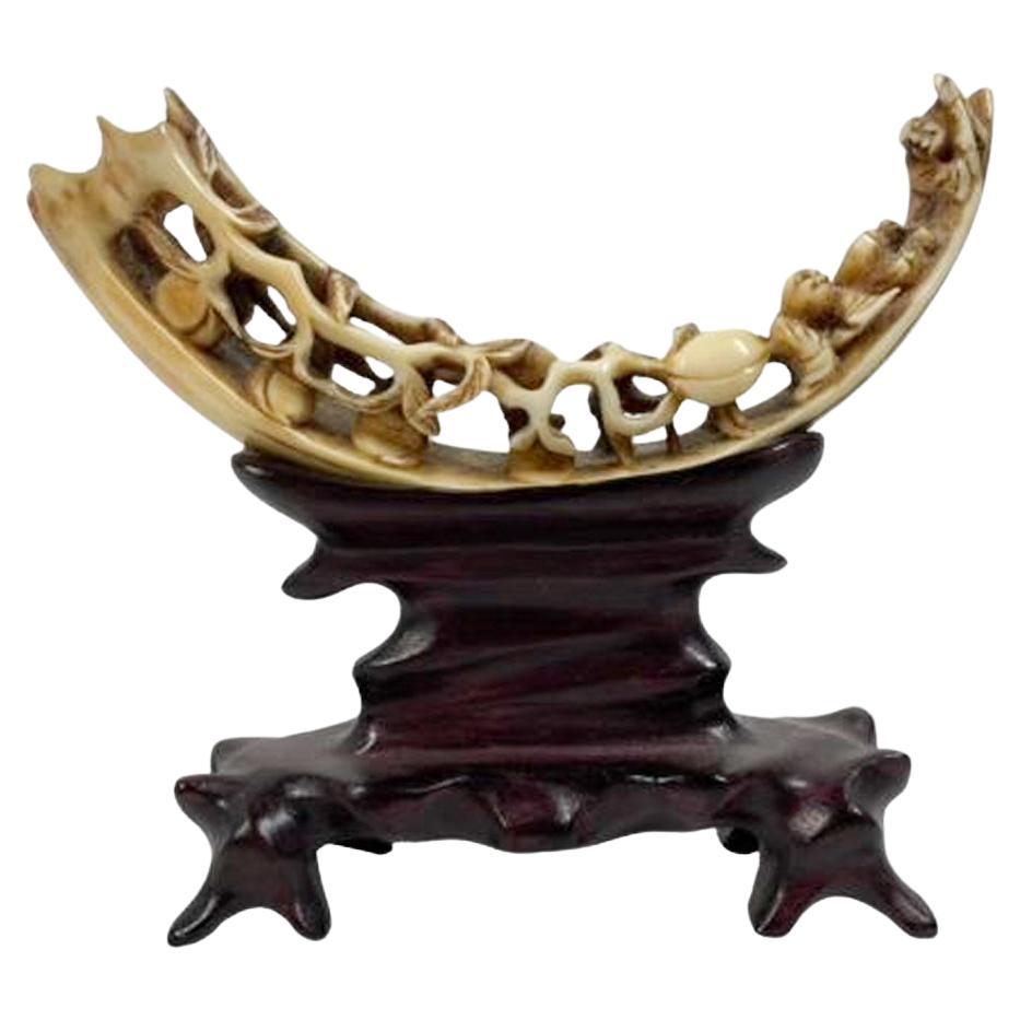 Antique Chinese Boar's Tusk with Carved Peaches on a Carved Hardwood Stand For Sale