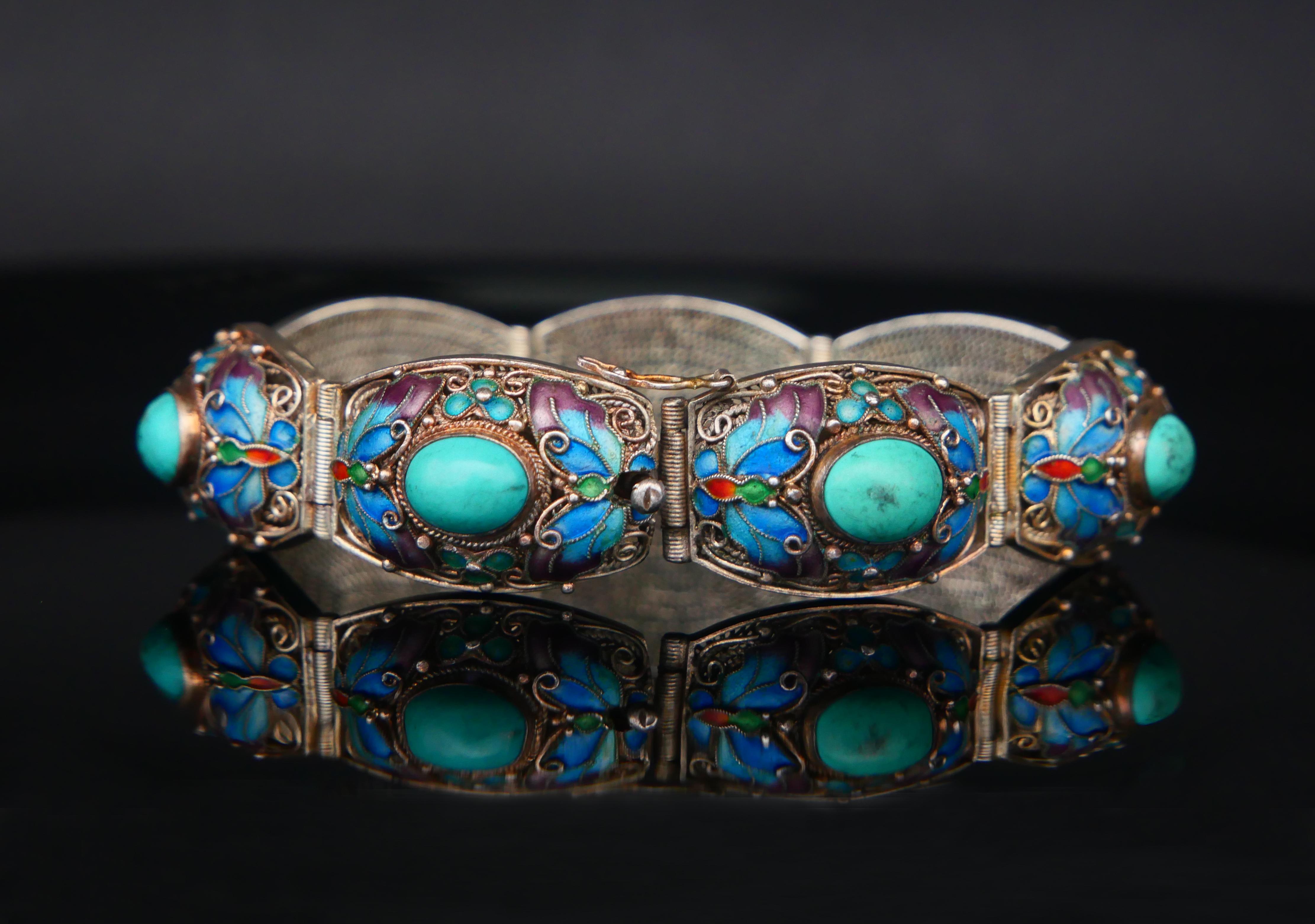 Old beautiful hand - made bracelet of finest quality.

There are 7 hinged Silver links made of meshed Silver with multiple  enameled and filigree wired elements soldered on top. Each section is housing a bezel set natural Turquoise stone cut
