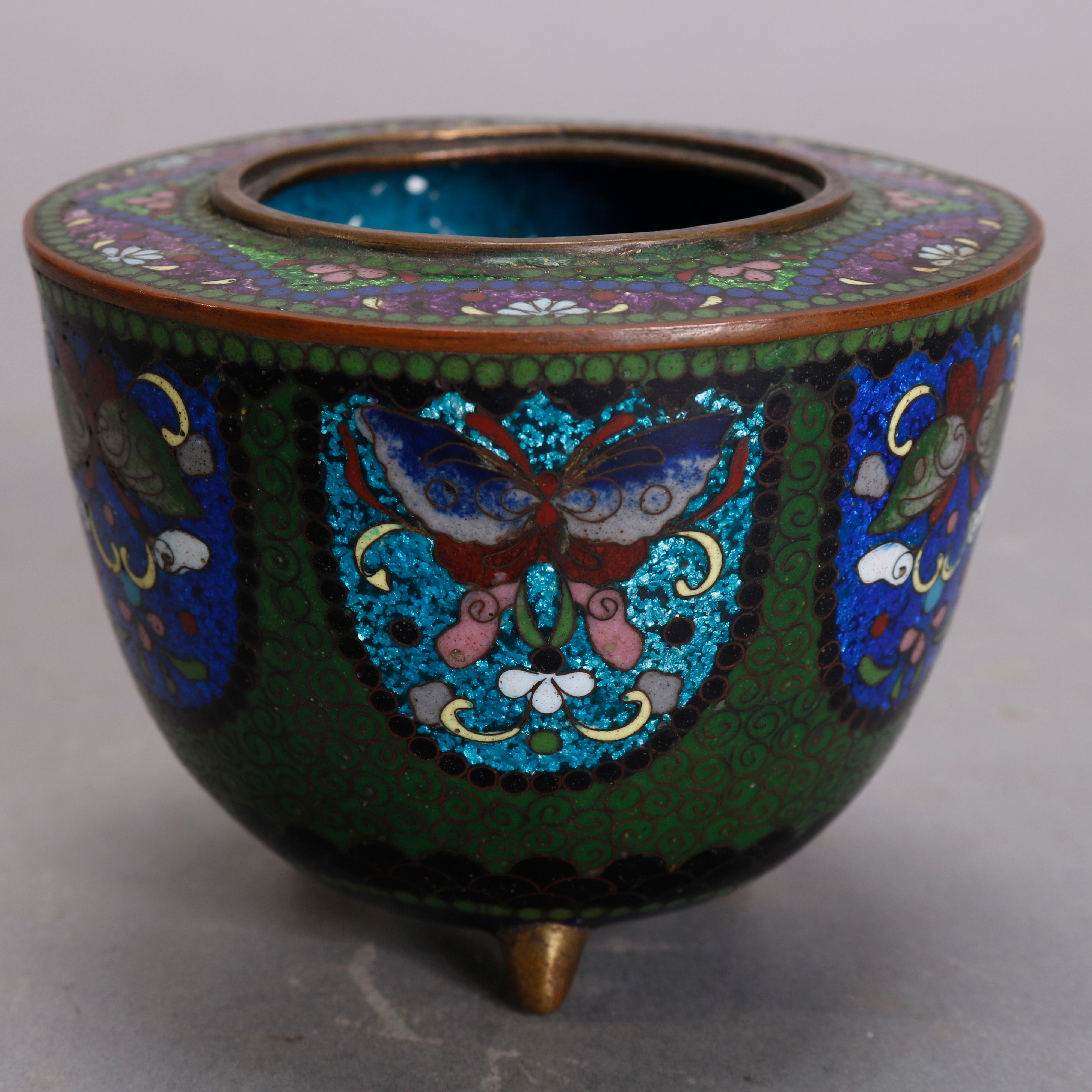 An antique Chinese Cloisonne lidded server offers enameled design with repeating butterfly reserves and floral collar, raised on three cone form feet, circa 1900.

Measures - 3.5