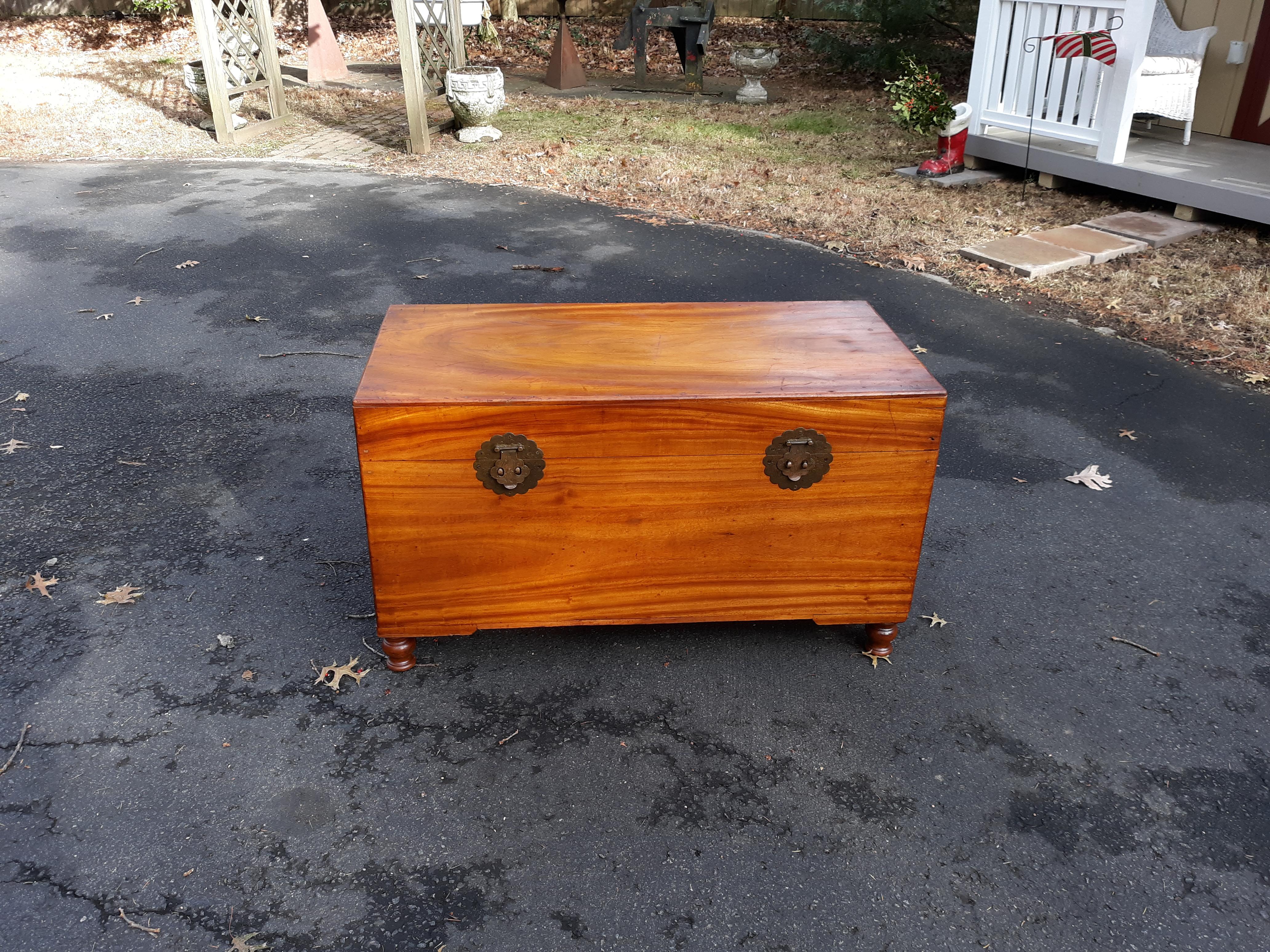 A large Chinese chest on turned feet with removable interior tray circa 1900, made from solid camphor wood. Overall very good condition showing some signs of age, shrinkage at joints and in grain, lacking key. Structurally sound and strong.