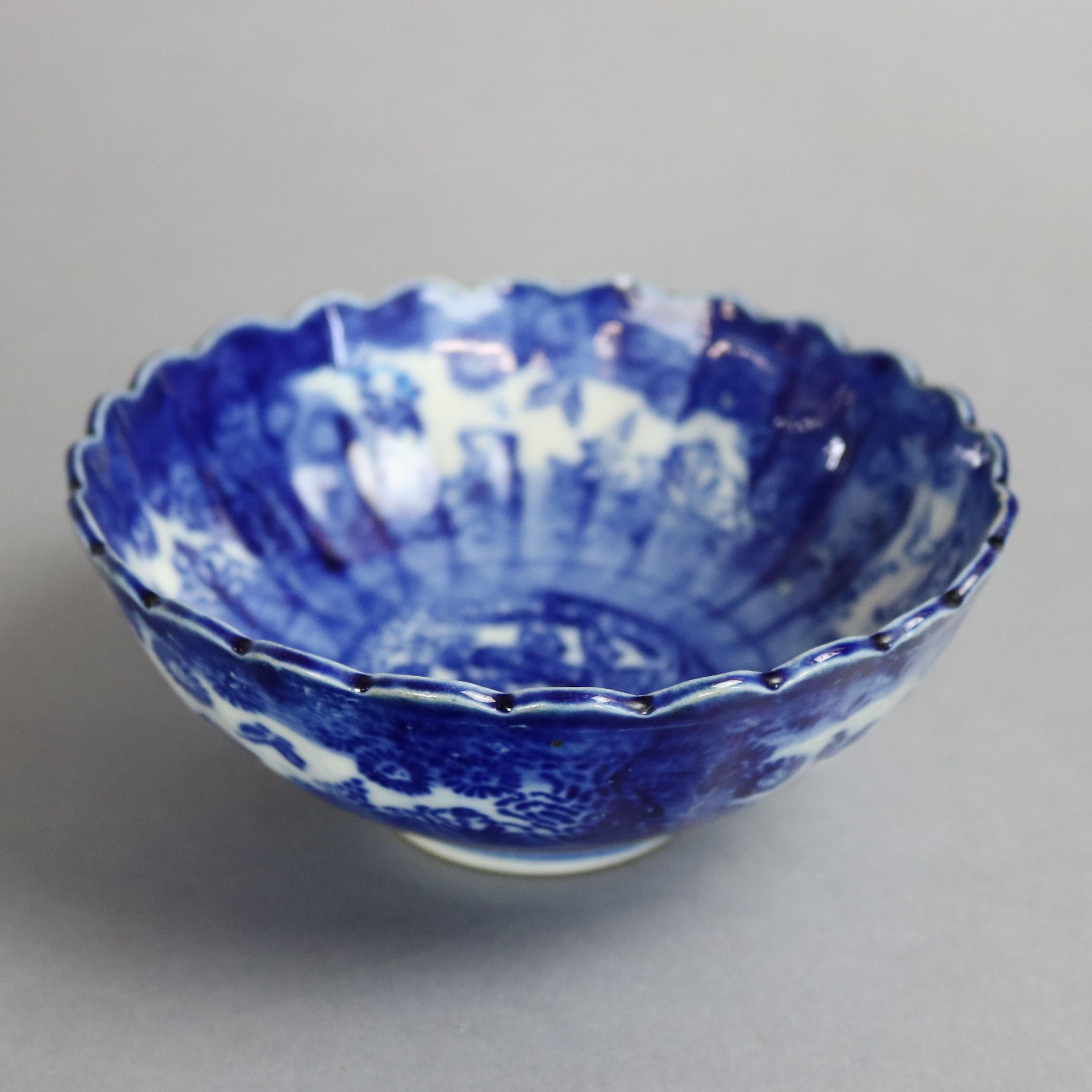An antique Chinese canton bowl offers blue and white painted porcelain with figures, foliate and floral decoration inside and out with scalloped rim, 19th century

Measures: 2.5
