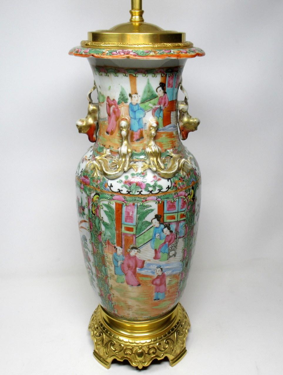 An exceptionally fine example of a Cantonese hand decorated Chinese export porcelain oil lamp no converted to an electric table lamp of good size proportions, with its original highly ornate mounts and lavish cast footed base, mid-19th