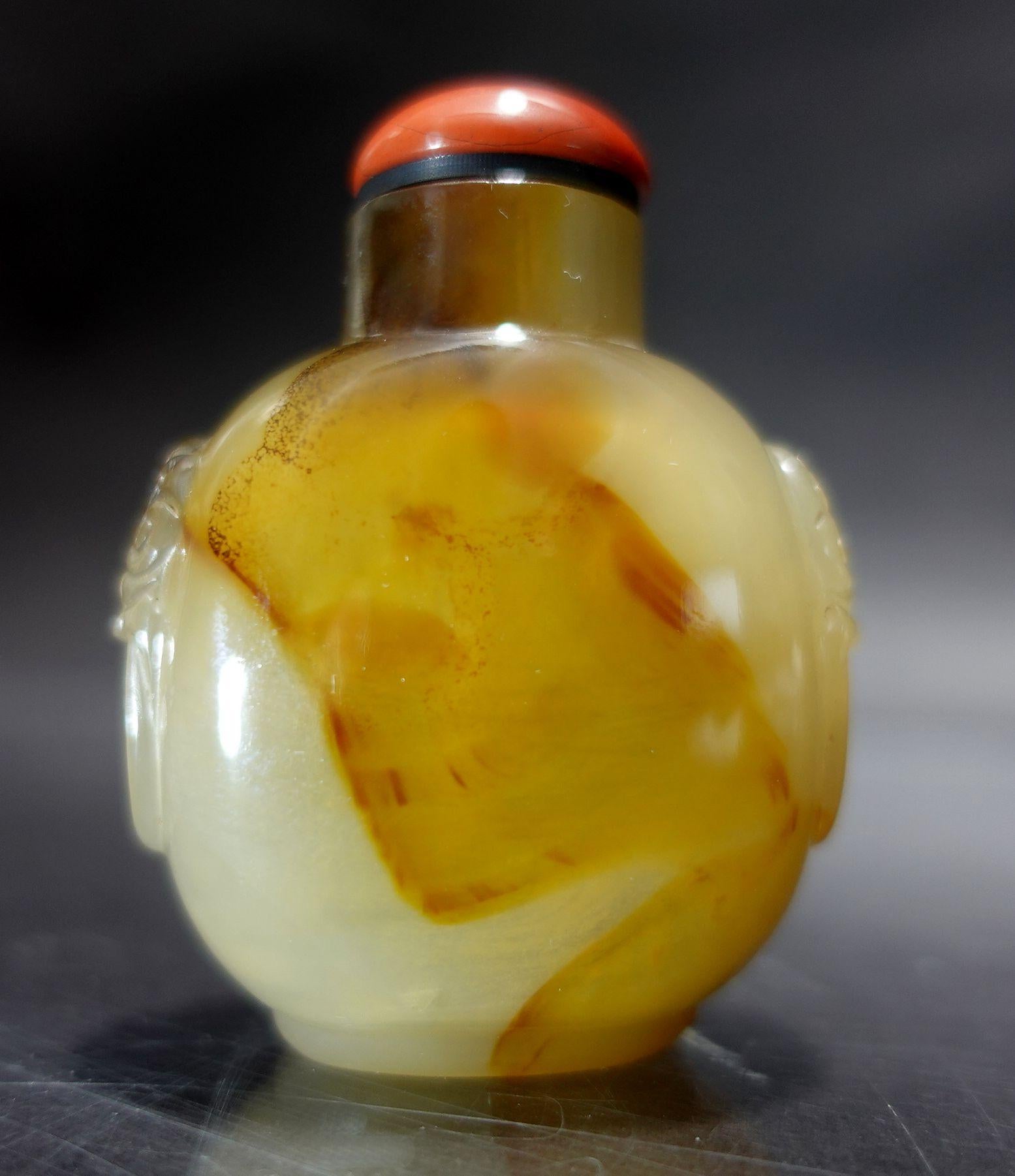 A fine and beautiful Carved Agate Snuff Bottle, with well hollowed interior with a coral cap.
A very fine selection for the highest quality of agate and skillful craftsmanship.
 