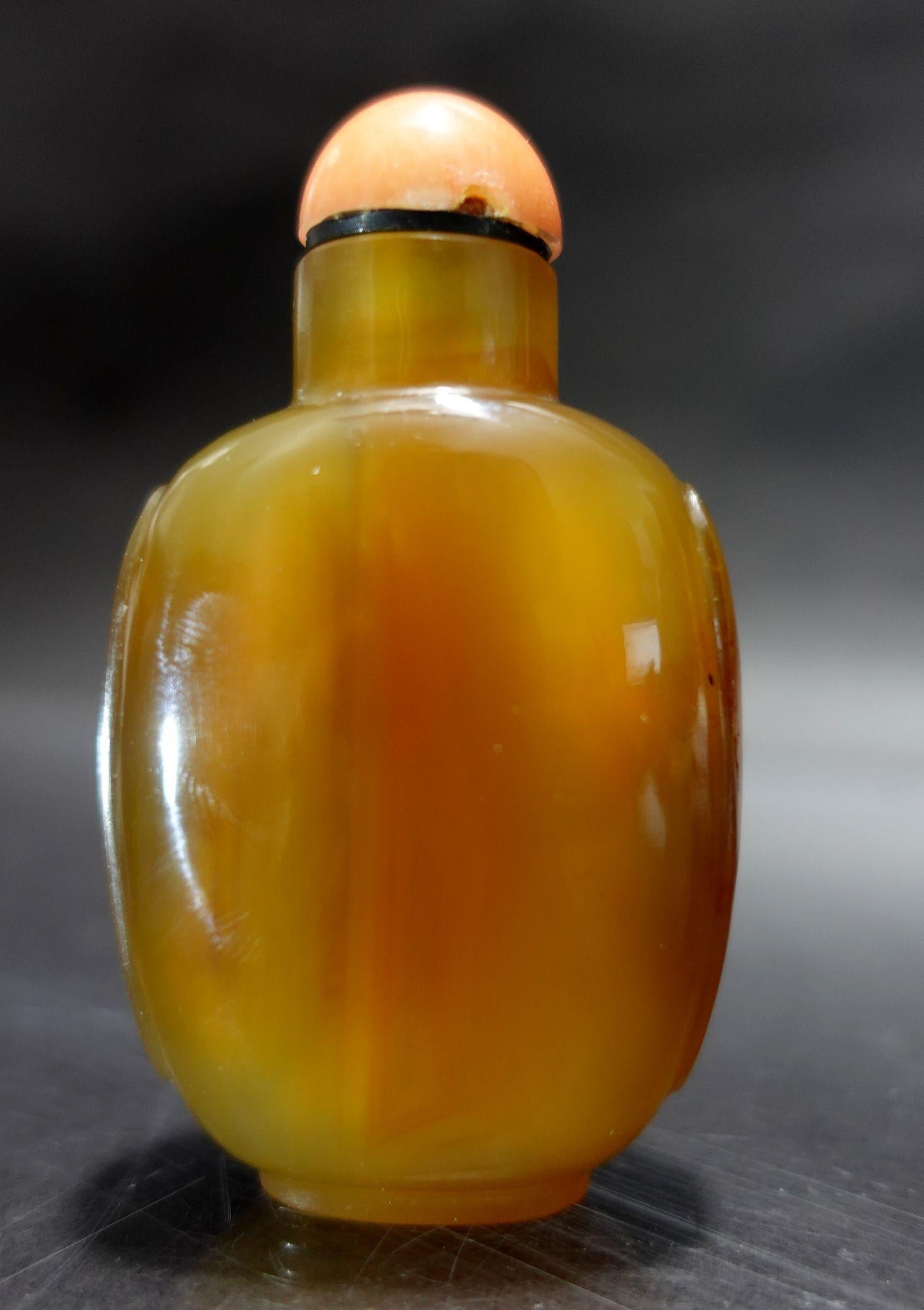 A fine and beautiful Carved Agate Snuff Bottle, with well hollowed interior with a coral cap.
The cap has a couple of small chips on the edge.
A very fine selection for the highest quality of agate and skillful craftsmanship.
 