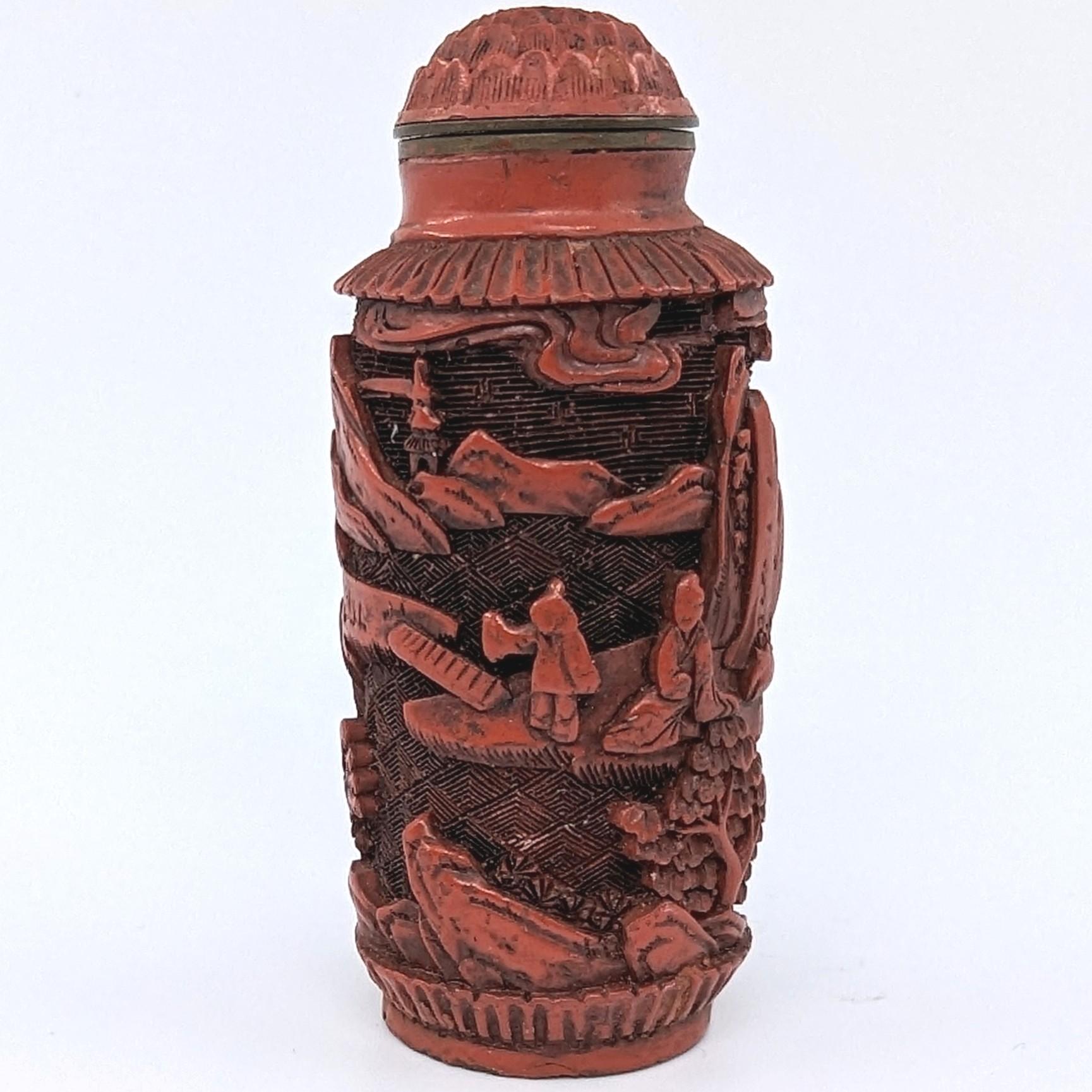 Antique Chinese red cinnabar lacquer snuff bottle, finely carved with a continuous landscape scene, original matching cinnabar stopper and 4 character Qing Qianlong mark to base

18-19c Qing Dynasty