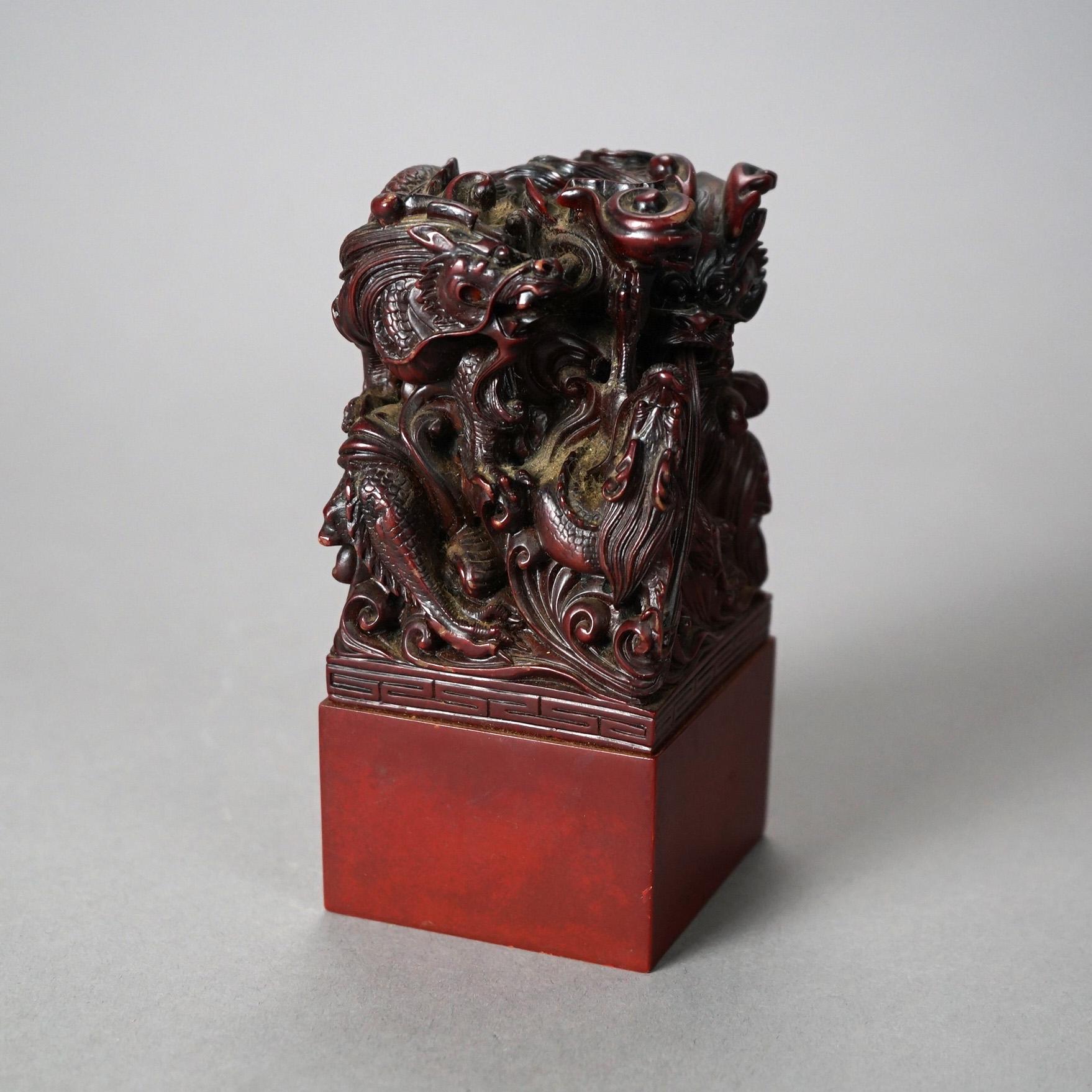 An antique Chinese figural group offers carved hardwood sculpture of intertwined dragons, circa 1920.

Measures - 5.5