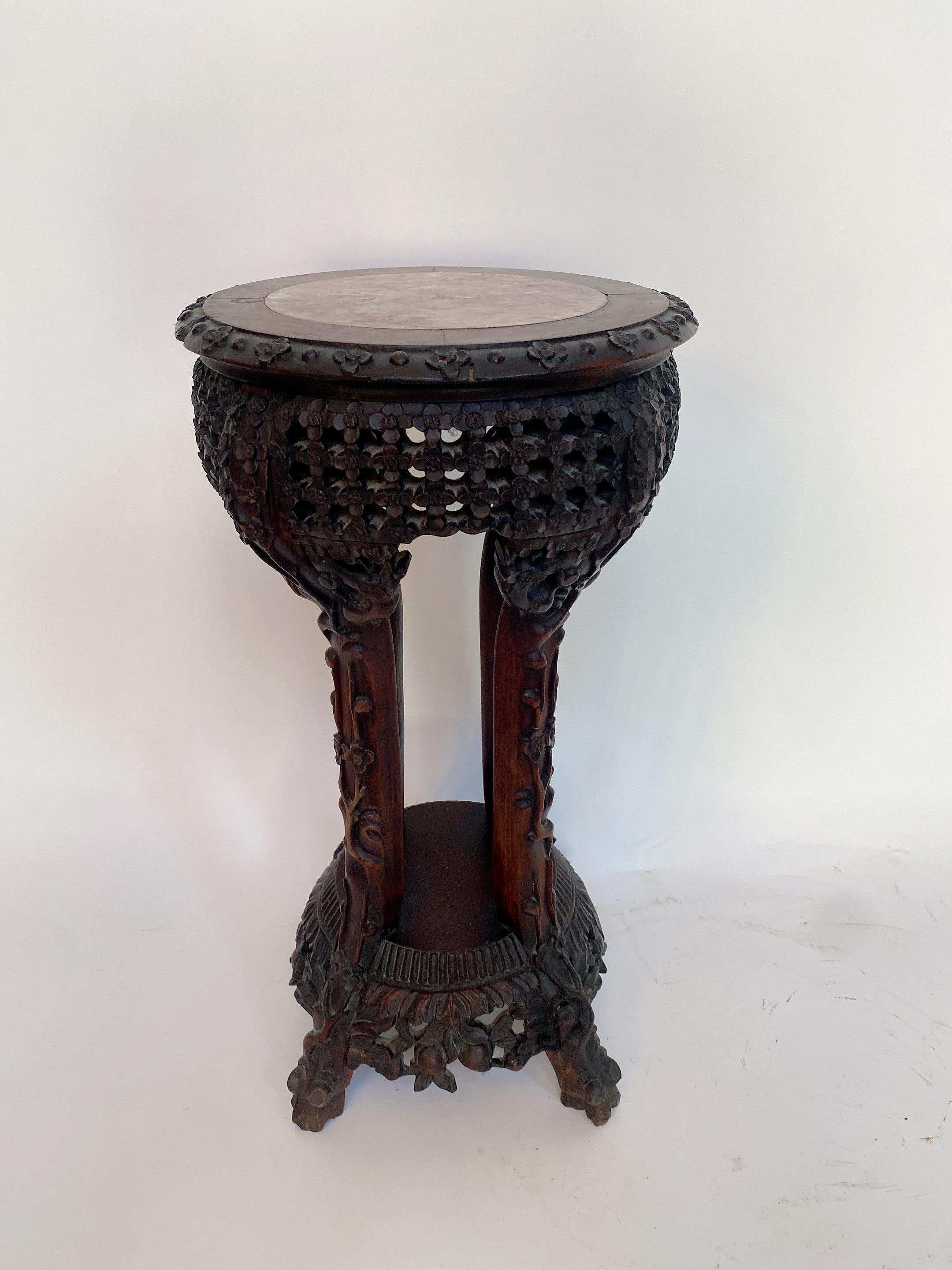 A antique Chinese heavily carved hardwood circular stand table with rouge marble top insert and dark wood carved with abundant floral motif , the inset marble top over carved hardwood apron design and unique 4 legs, see more pictures, measures: 20