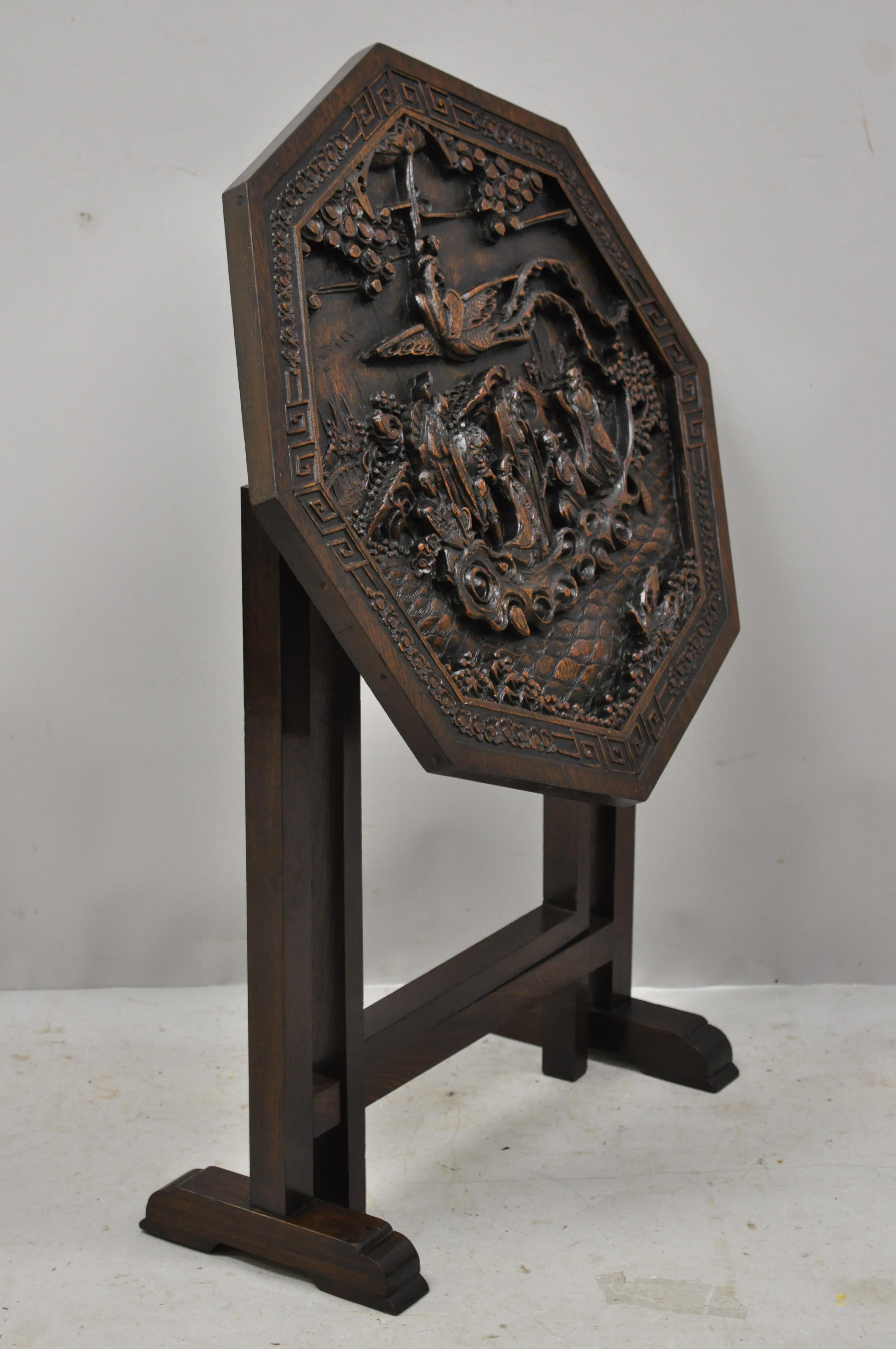 Antique Chinese carved hardwood folding gate leg table with figural carvings. Item features relief carved figural top, fold out base, flip top, solid wood construction, very nice vintage item, great style and form, circa mid-20th century.