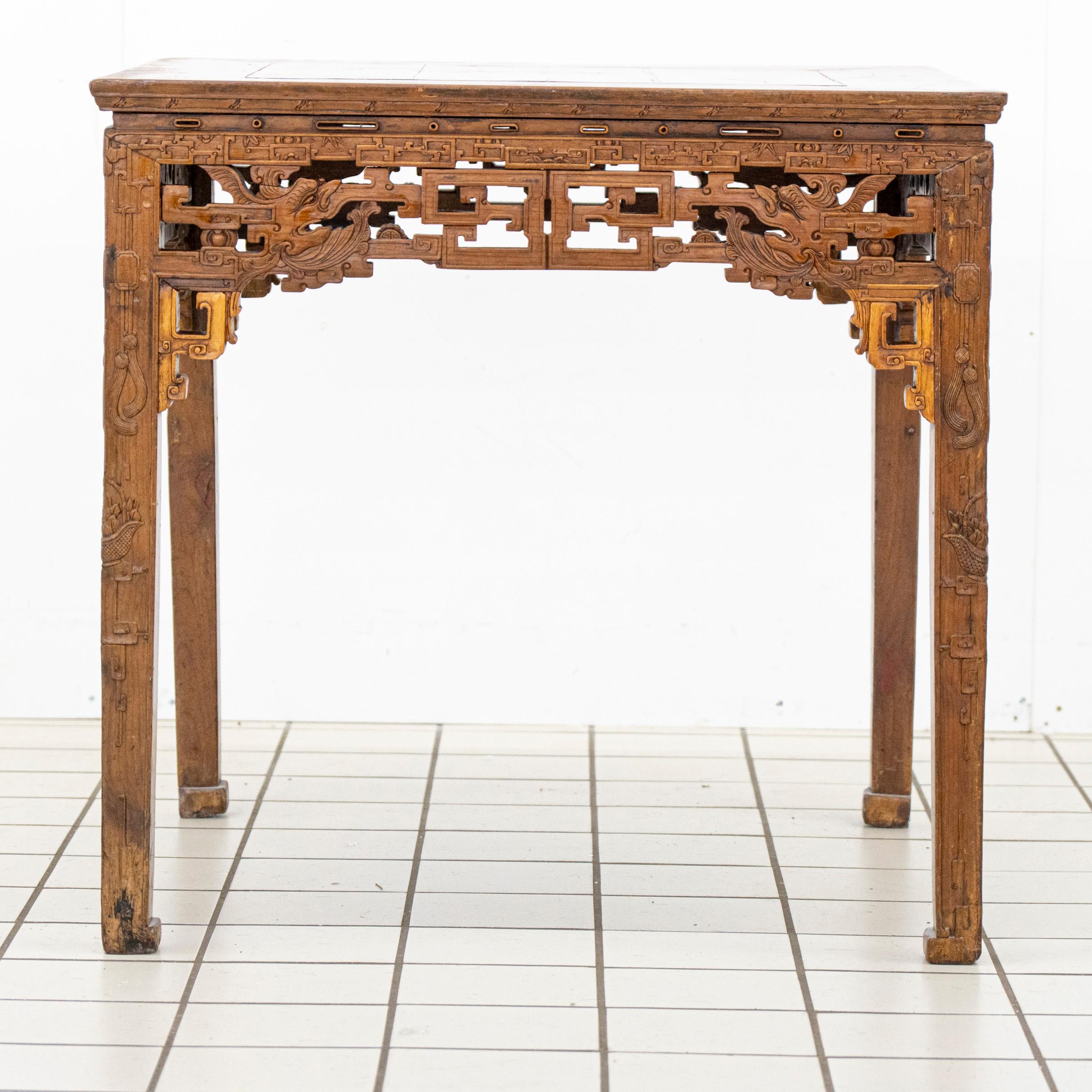 This antique Chinese wooden table showcases intricate huiwen fretwork, a traditional geometric motif symbolizing continuity and prosperity. The apron and leg joints feature openwork (lòukōng diāokè, 镂空雕刻) with interlocking huiwen patterns,