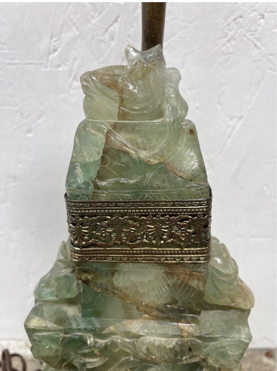 Antique Chinese Art Deco era carved jade table lamp. Featuring a carved scholar stone style mount with brass separation between the main body and lid. 