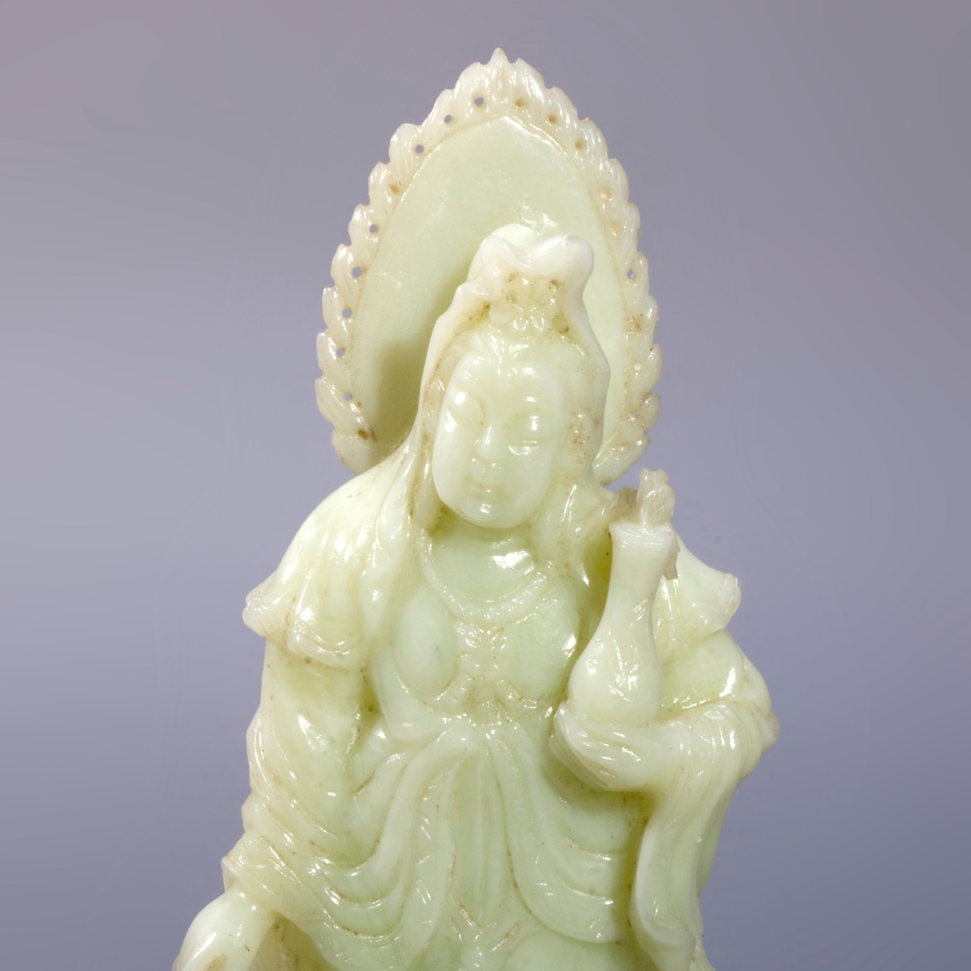 An antique Chinese carved jadeite figure of woman with vase on hardwood base, 20th century

Measures- 8