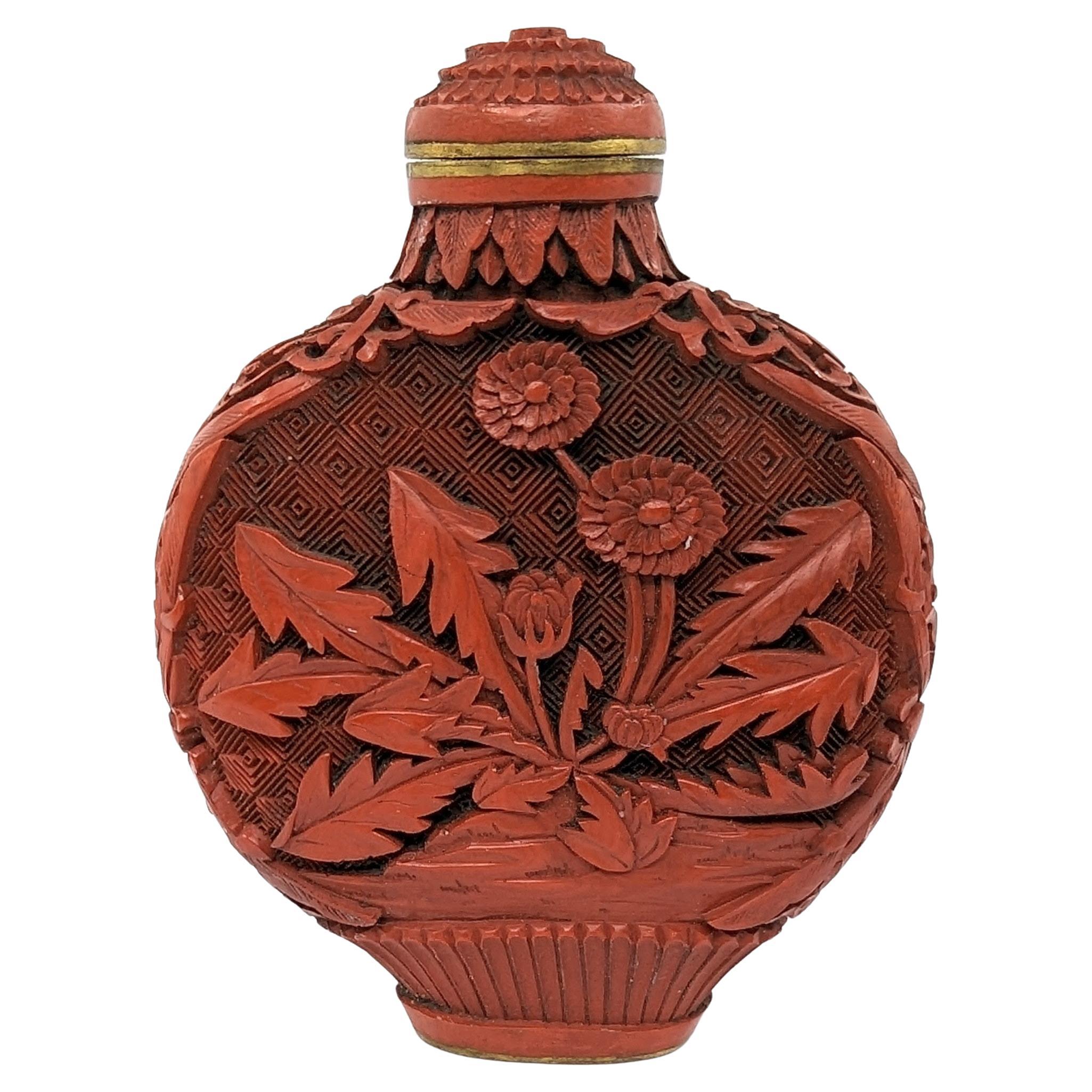 Antique Chinese red cinnabar lacquer snuff bottle of flattened globular form and well carved with chrysanthemums and flowers, matching cinnabar stopper, wooden spoon

18th to 19th Century Qing Dynasty
