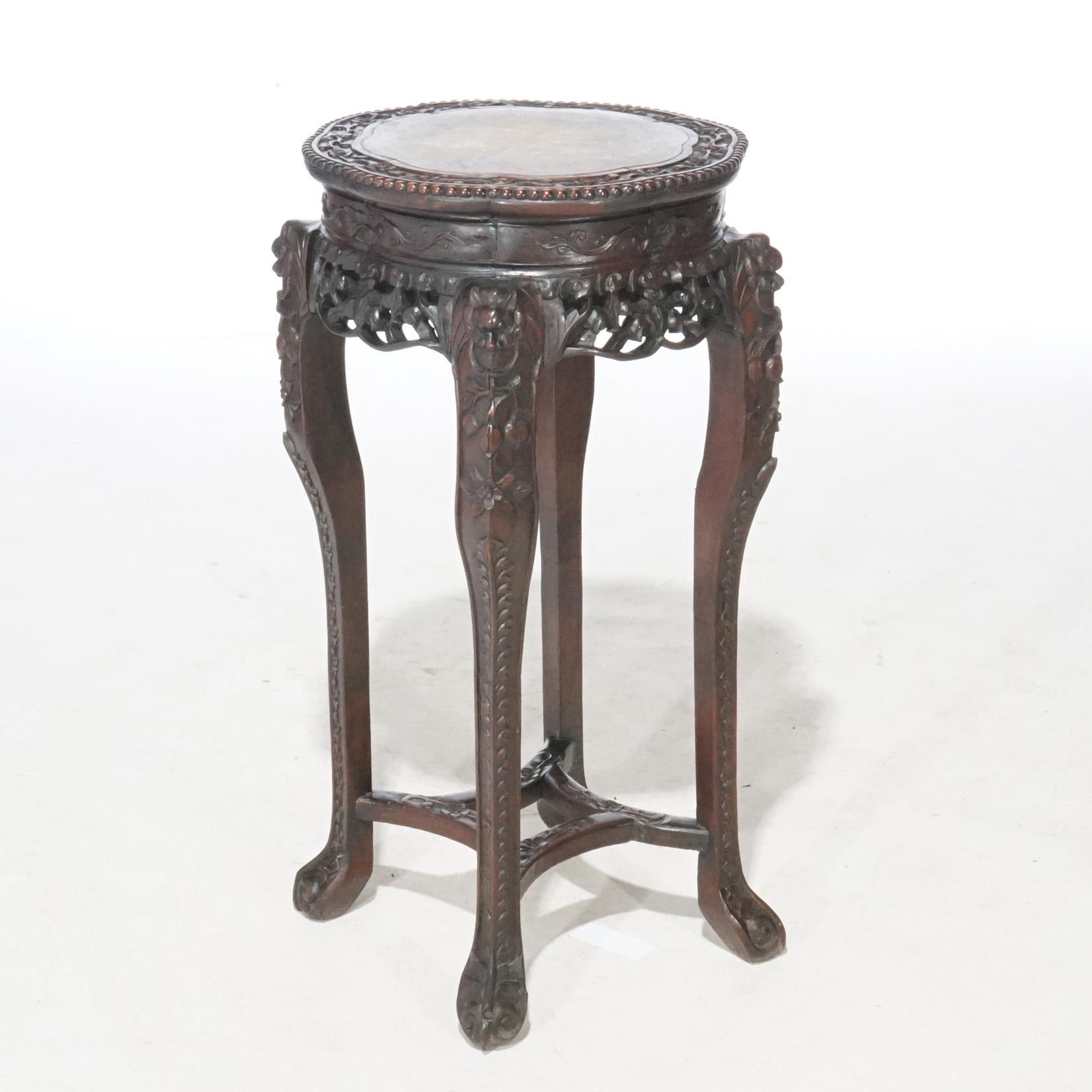 An antique Chinese fern stand offers rosewood construction with inset marble top over foliate carved base, circa 1920

Measures - 35.25