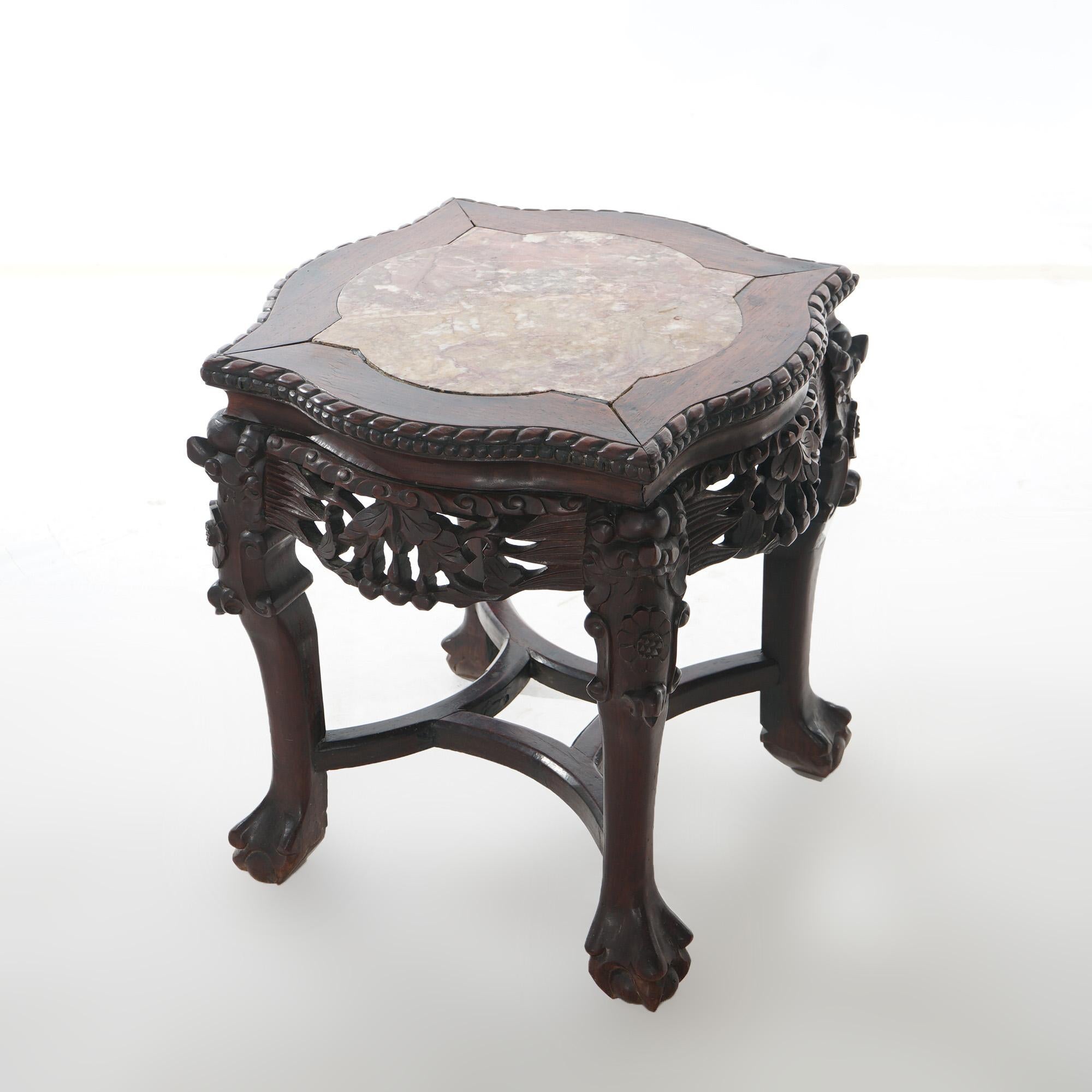 An antique Chinese low table offers rosewood construction with shaped picture frame marble top having beaded trim over deeply carved foliate skirt and raised on paw feet, c1920

Measures- 18''H x 20.5''W x 20.5''D