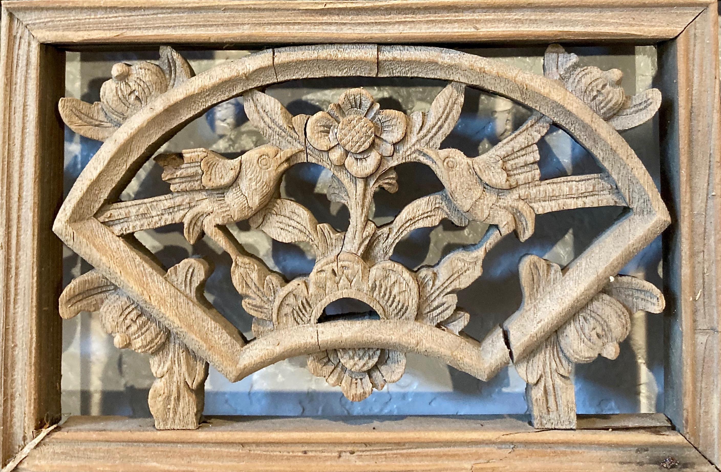 Thick framed panel with three panes, openwork and relief carvings, and lattice work. Fan shaped center carving with bird/floral motif. Lower pane includes personage and dwelling motif.