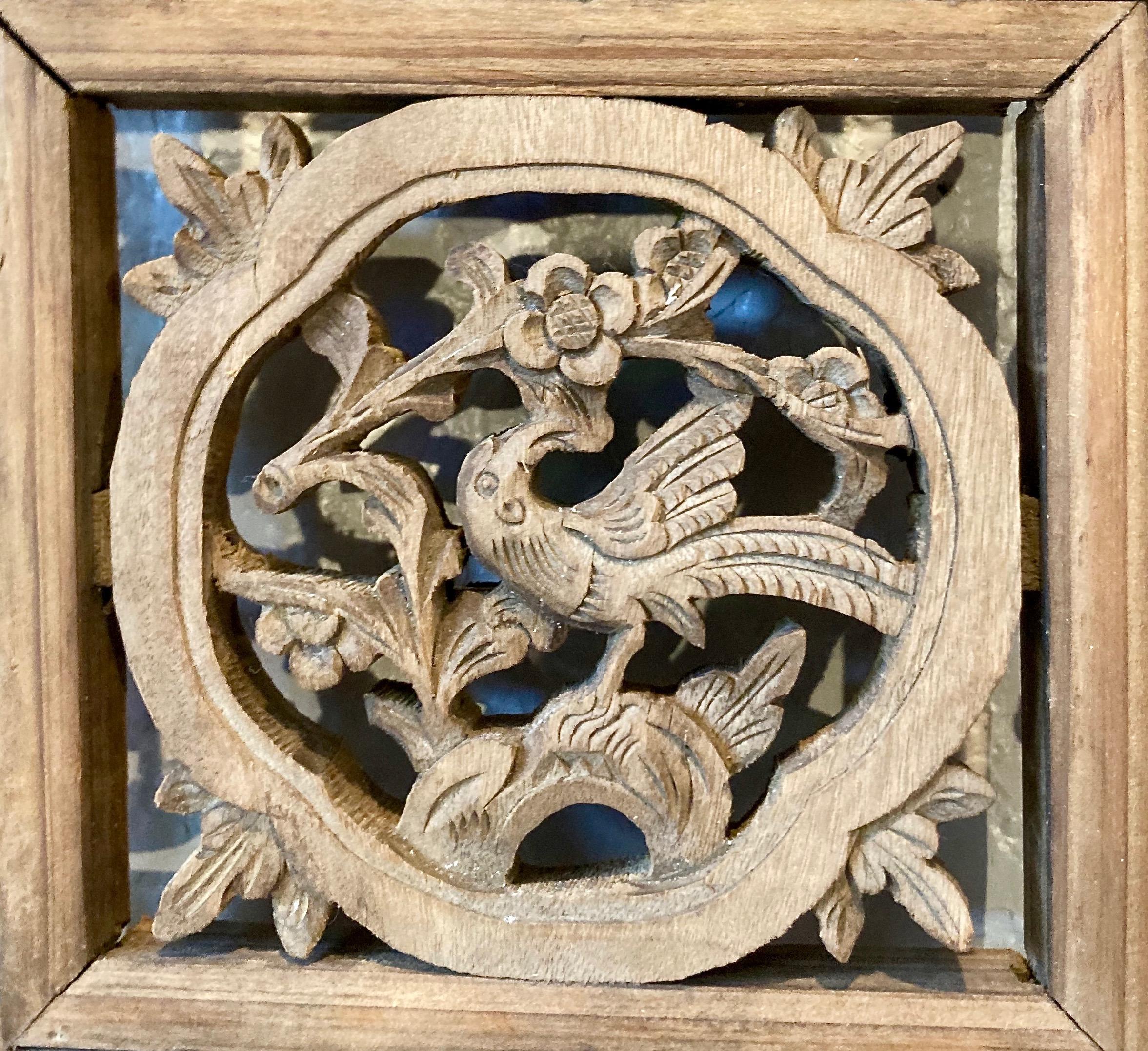 Thick framed panel with three panes, openwork and relief carvings, and lattice work. Circular shaped center carving with bird/floral motif. Lower pane includes animal and bird motif.