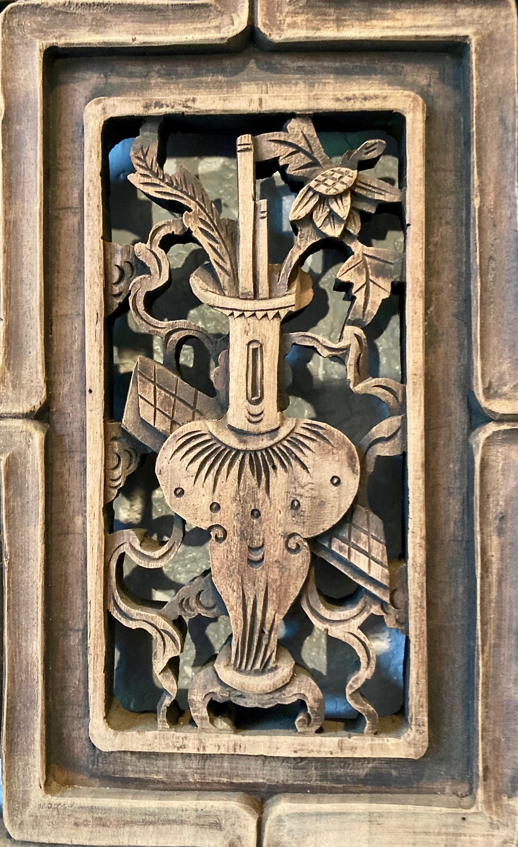 Thick framed panel with three panes, openwork and relief carvings. Rectangular center carving with vase/floral motif. Bottom pane with plant/bird motif.