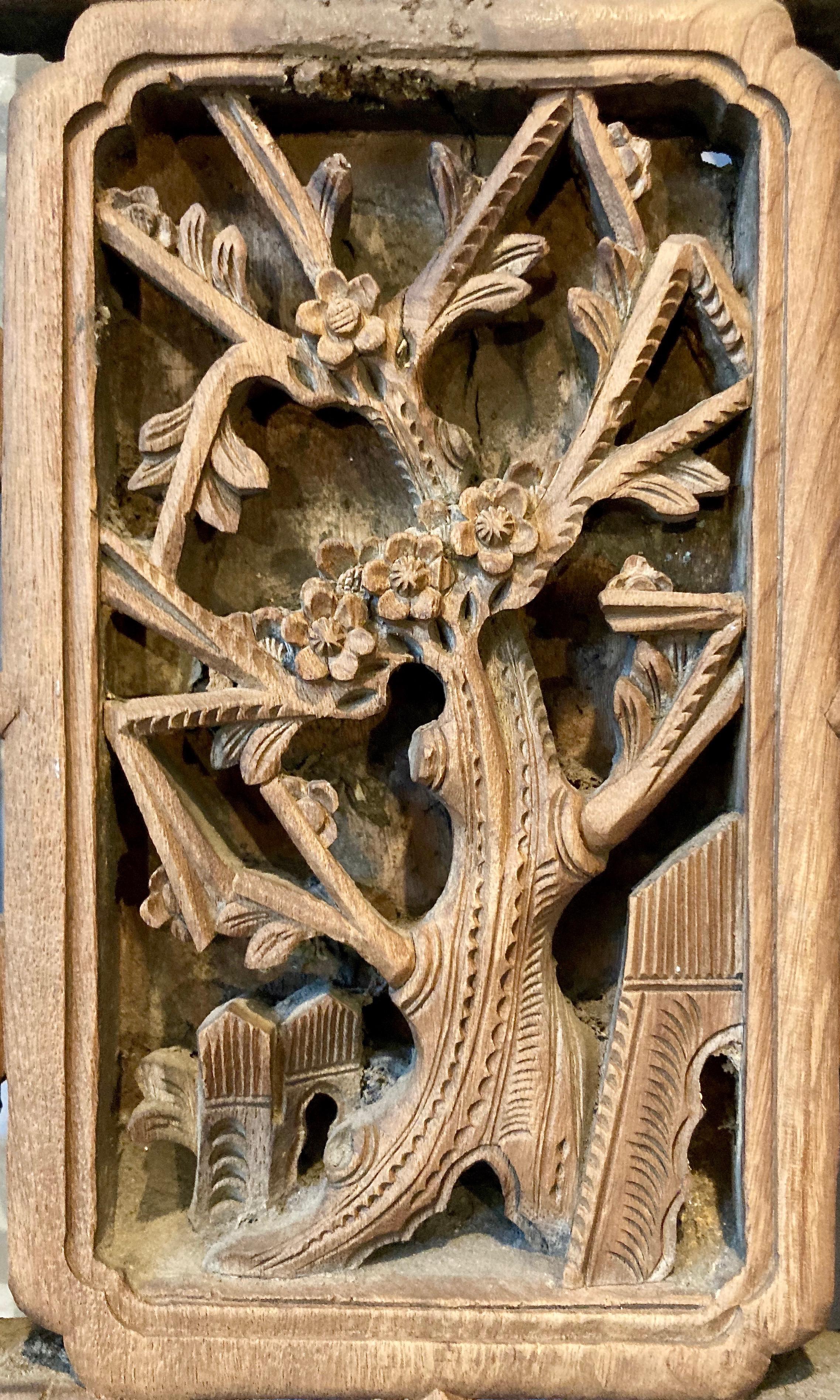 Framed panel with three panes, openwork and relief carvings. Rectangular center carving with plant motif surrounded by carved open framework motif.