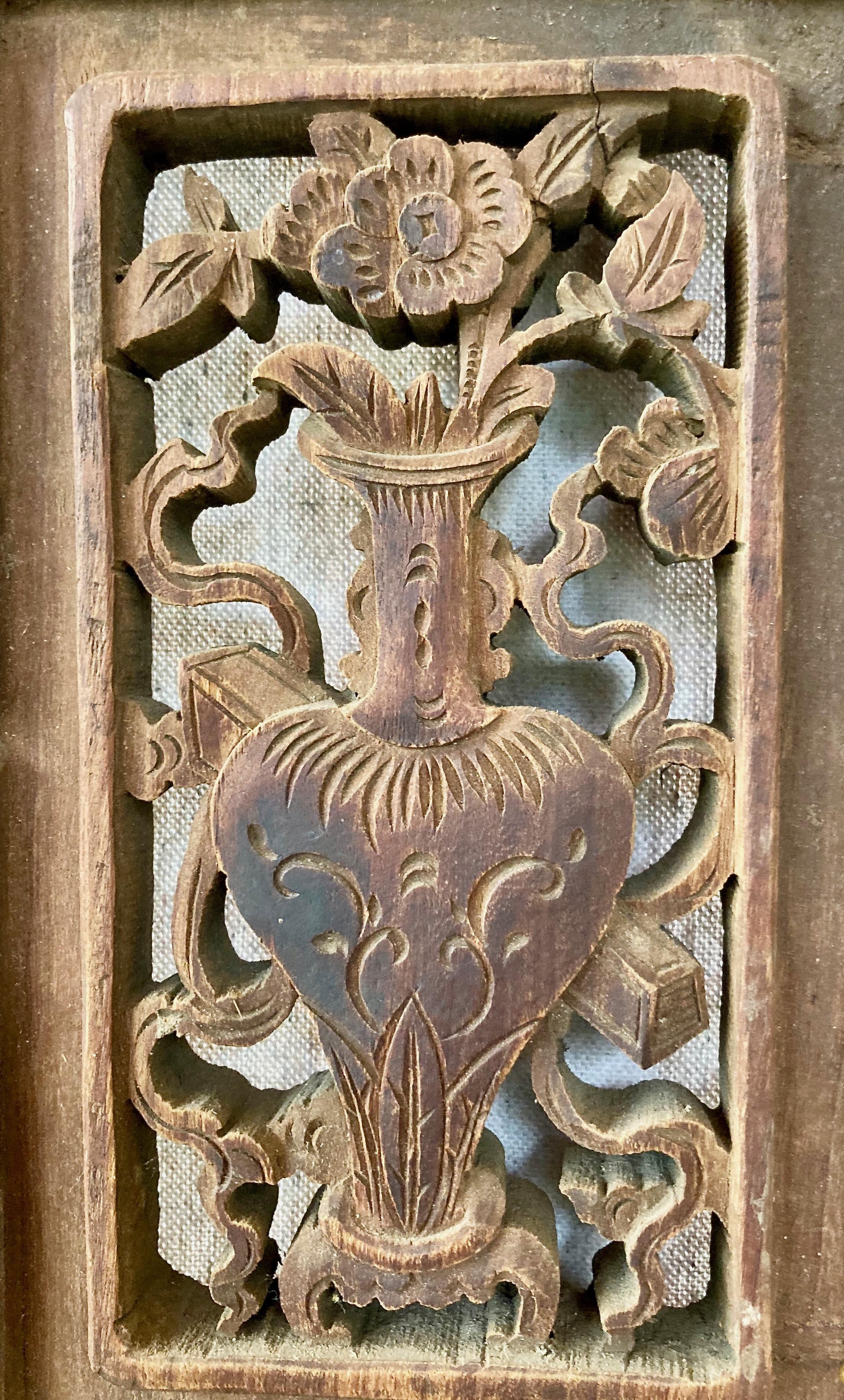 Thick framed three-pane panel includes openwork and relief carvings, and a rectangular center carving with vase/floral motif. Lower relief carved pane has bird motif.