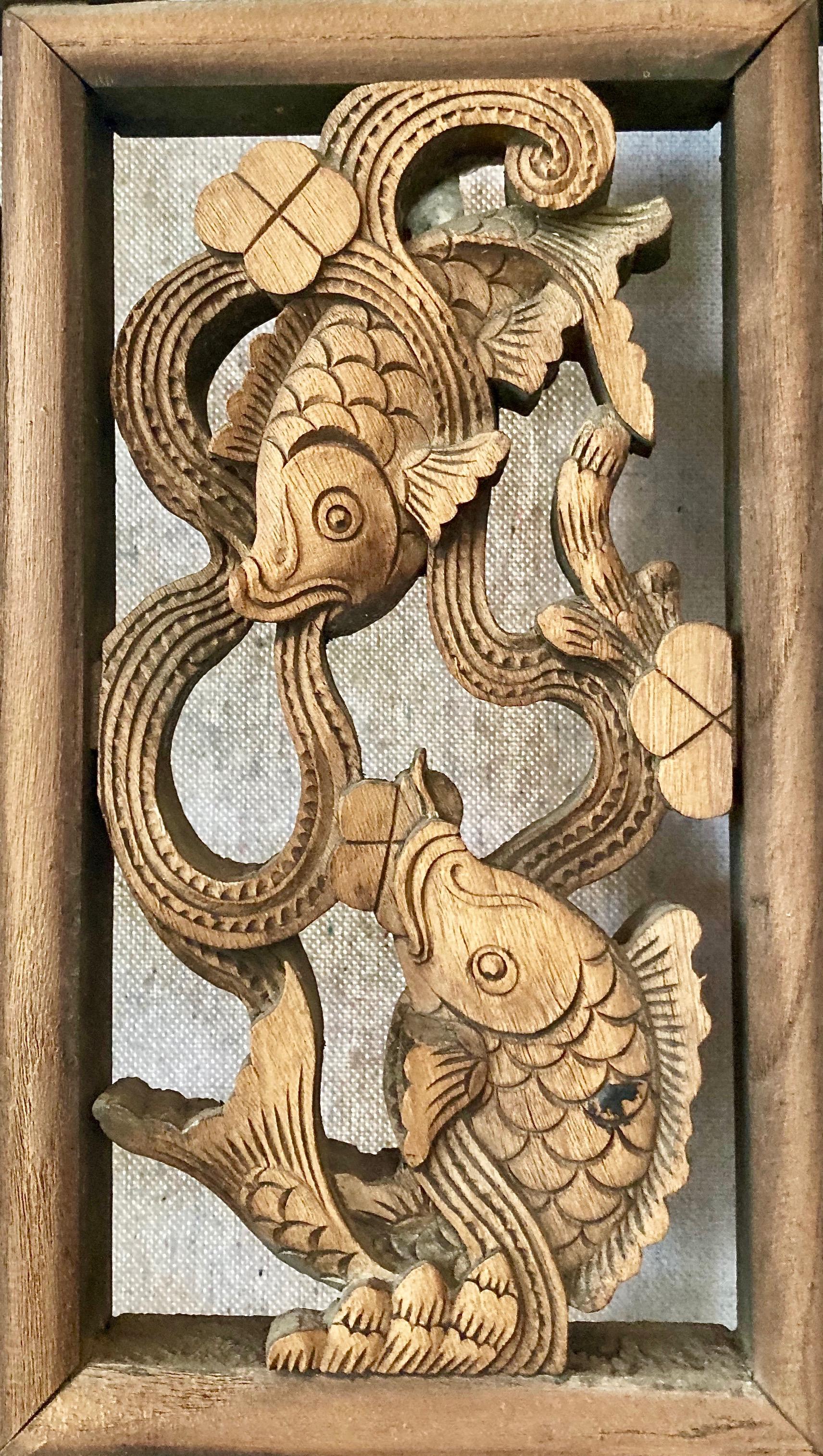 Heavy, thick framed three-pane panel includes openwork carving, relief carving + lattice work techniques. The rectangular center carving includes a pleasant fish motif. The lower pane features personage sharing a drink.