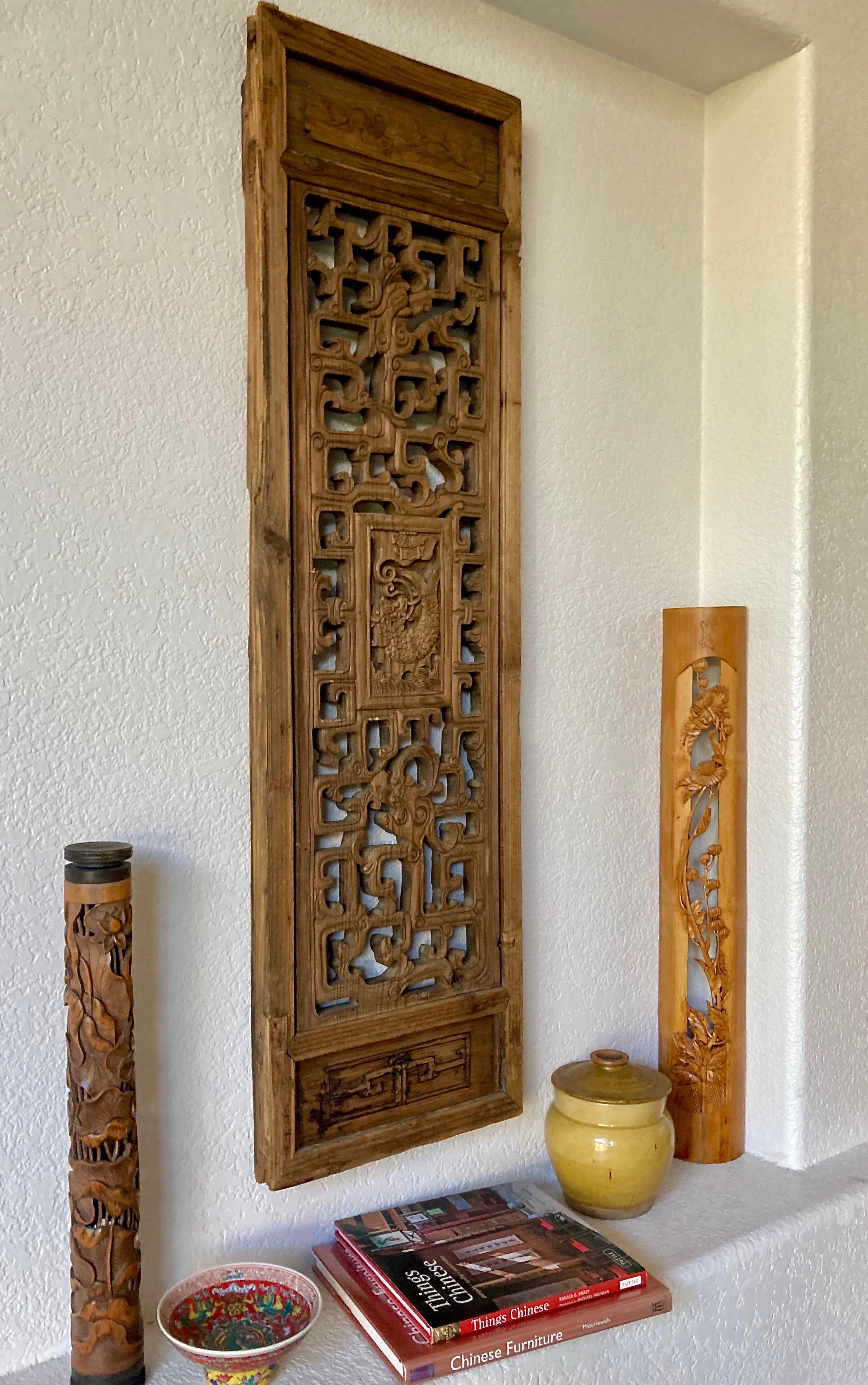 This well crafted piece includes a rectangular center carving with a mythological fish creature and a surrounding dragon motif. Carved from a solid piece of wood with a thick mortise and tenon joined frame.